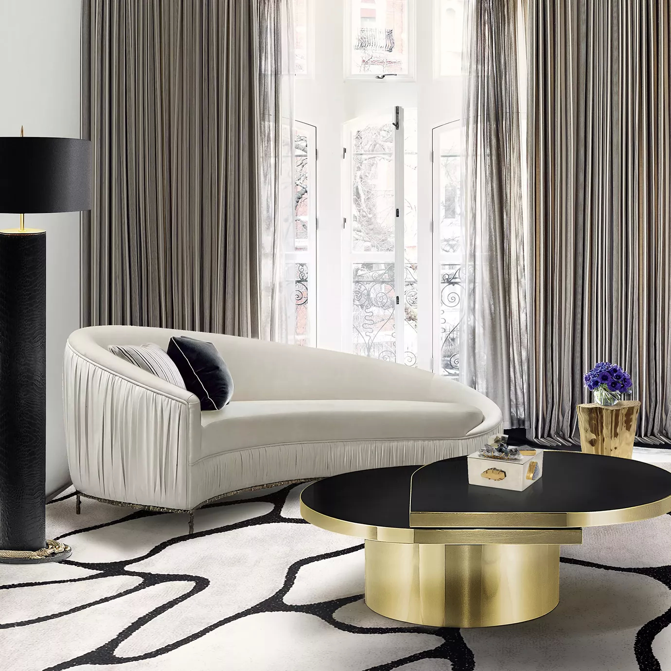 Luxurious living room with curved sofa and Tears polished brass coffee table.