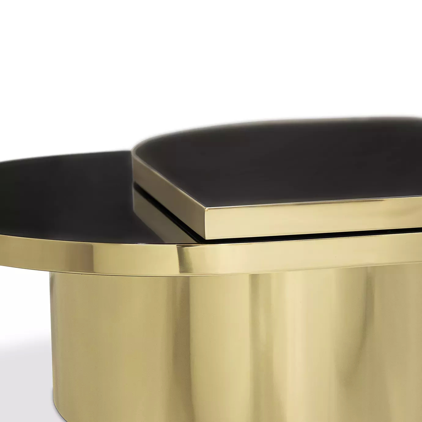 Close-up of the two-tiered black top and polished brass base of the Tears table.