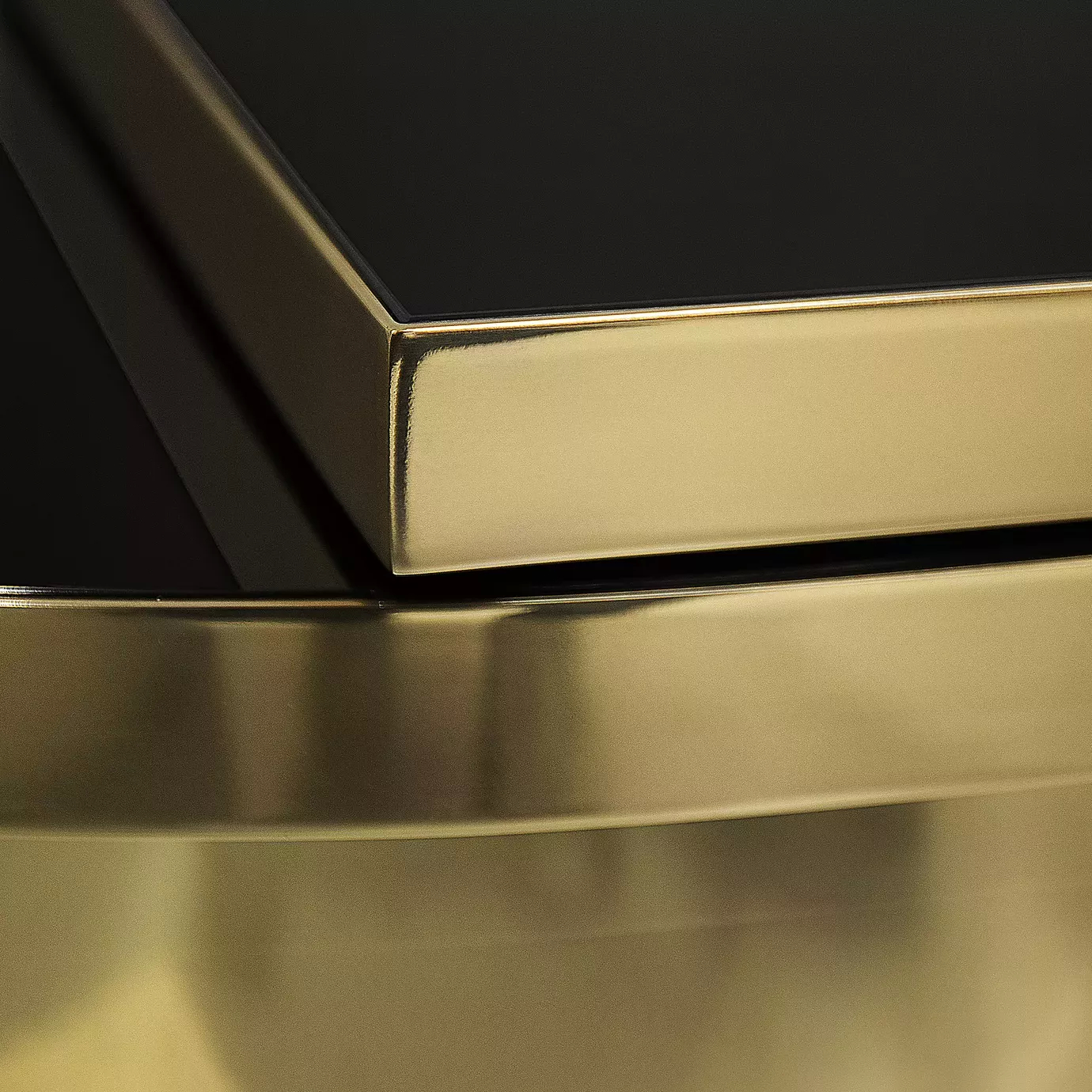 Detail of the polished brass finish and black top of the Tears table.