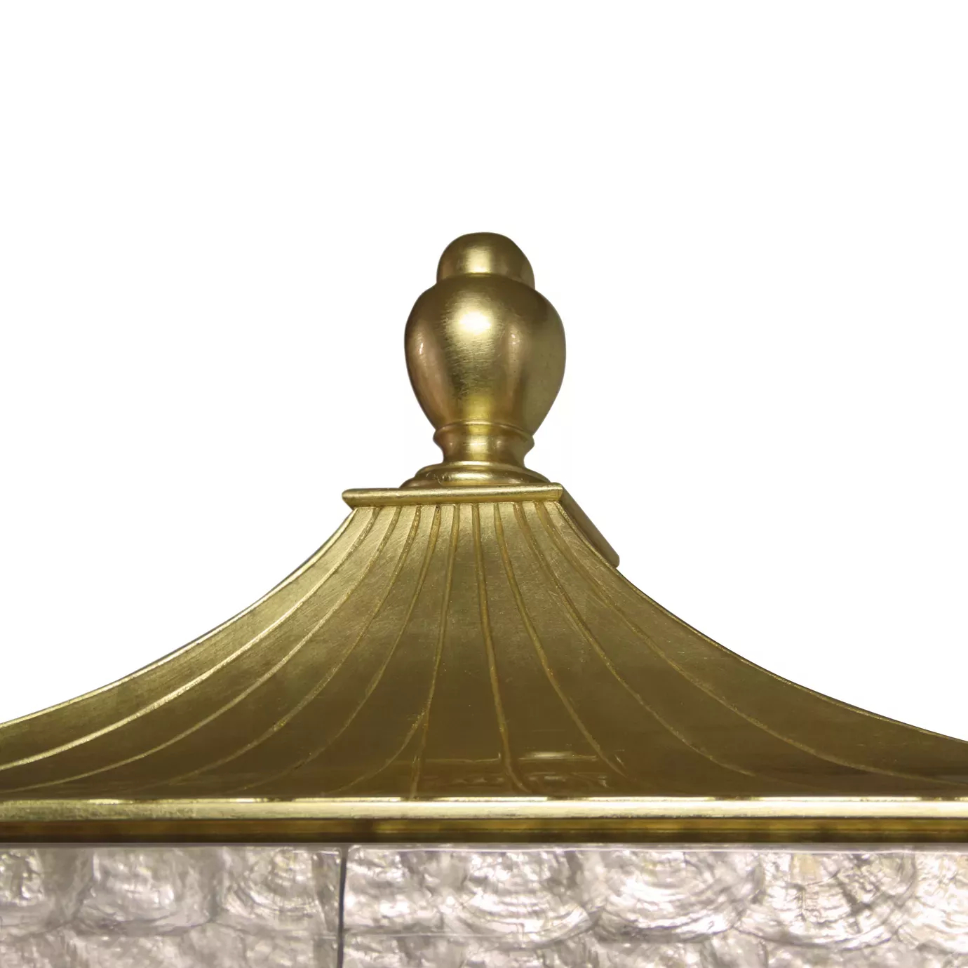 Detail of the elegant golden top of the Camilia armoire.