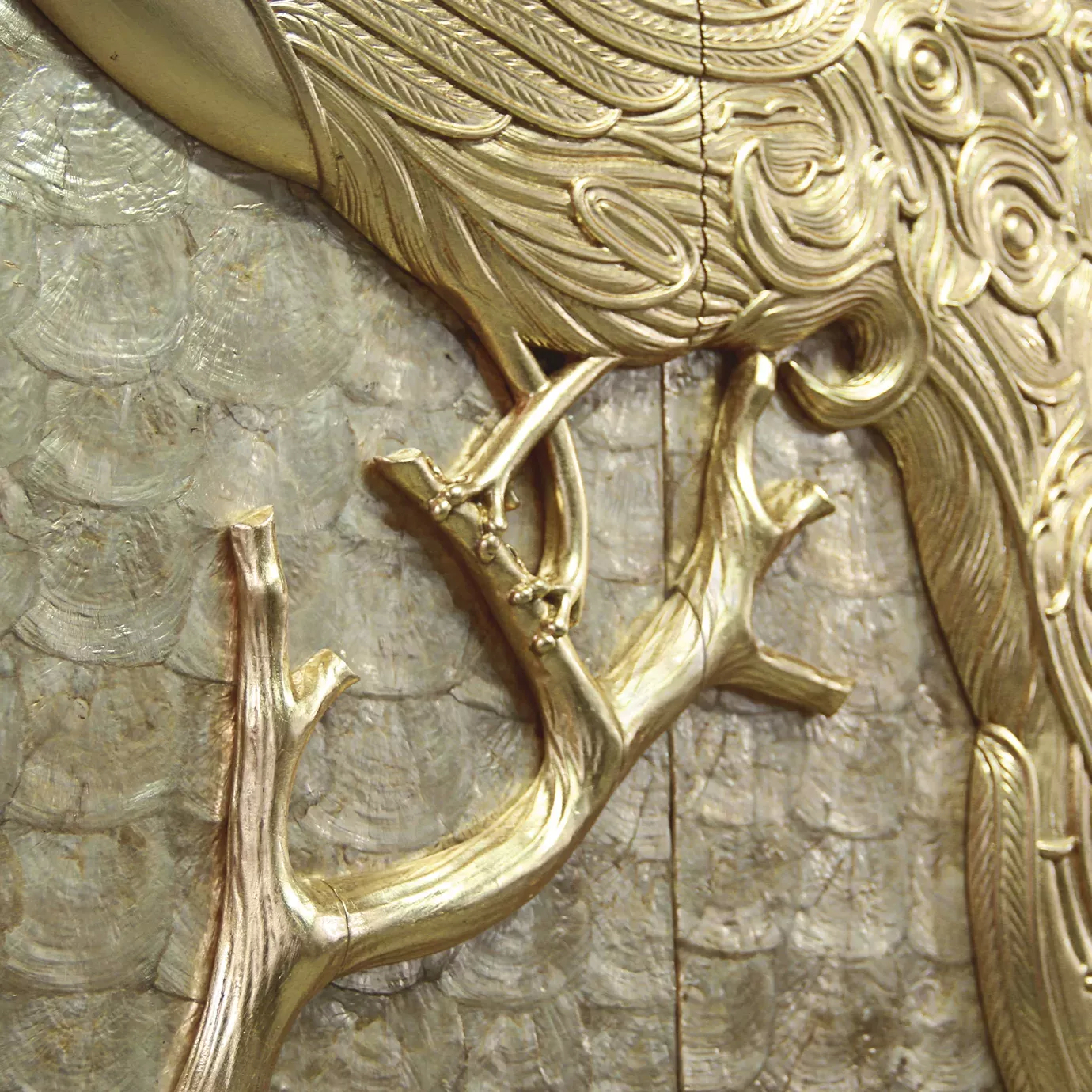 Elegant detail of the golden peacock feet on the Camilia armoire.