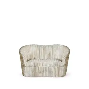 Kelly Loveseat: A stylish, compact sofa with a unique curved silhouette and detailed vertical channel tufting throughout.