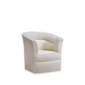 Lovely Armchair, slight angle: A plush, curved armchair in a soft, creamy hue with distinctive vertical channel tufting on the back and sides.