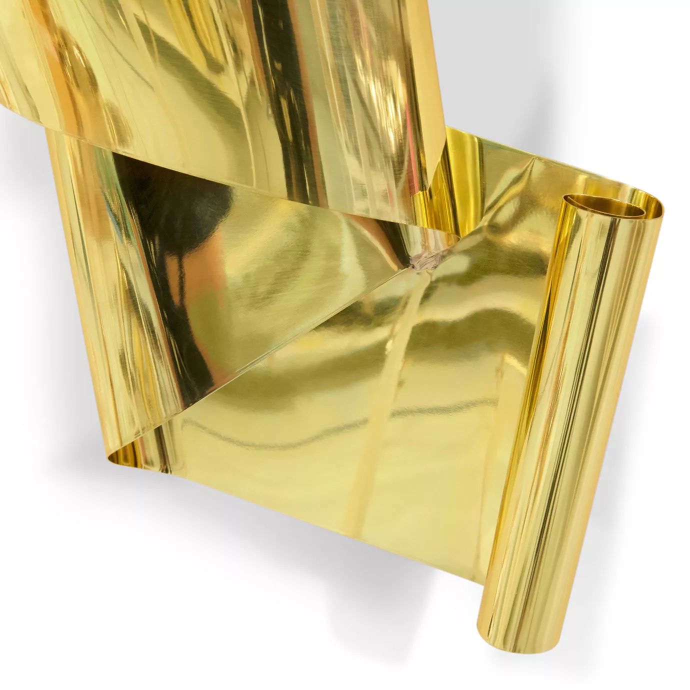 A detail shot of the polished gold sculpture, emphasizing its smooth, reflective surfaces and dynamic, curving lines.