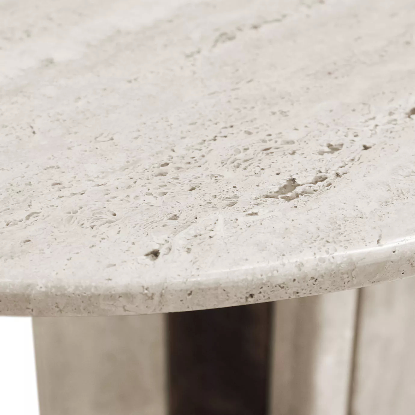 Paris Oval Dining Table, tabletop close up: A detailed view of the smooth, porous texture and subtle variations in the light travertine marble.