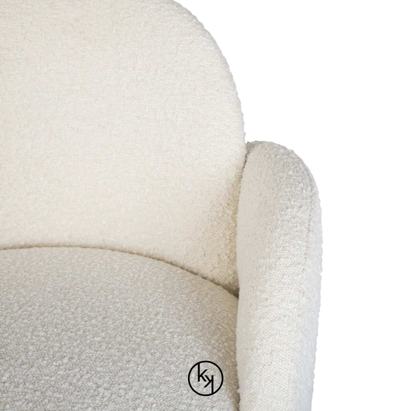 Close-up on the Oh-lá-lá Chair's armrest, showcasing its soft, textured white upholstery and gentle, inviting curve.