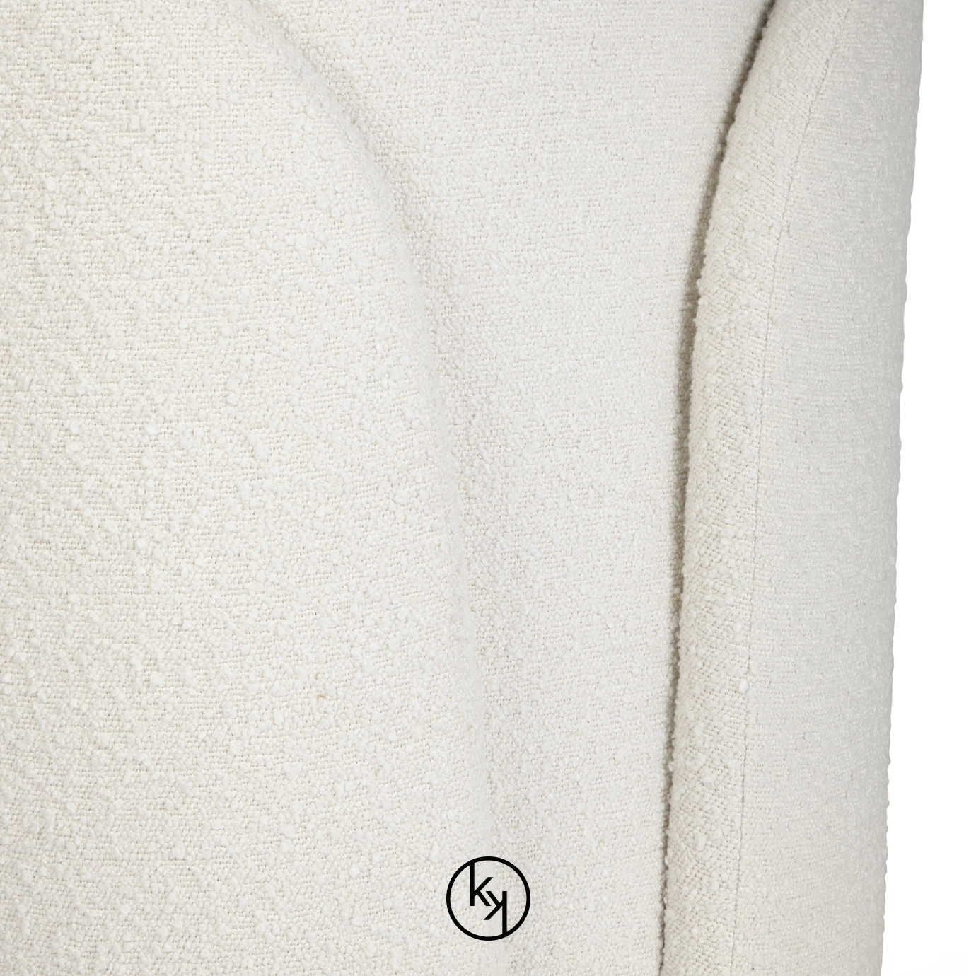 Close-up on the Oh-lá-lá Chair highlighting its soft, textured white fabric and the chair's gentle, flowing lines.