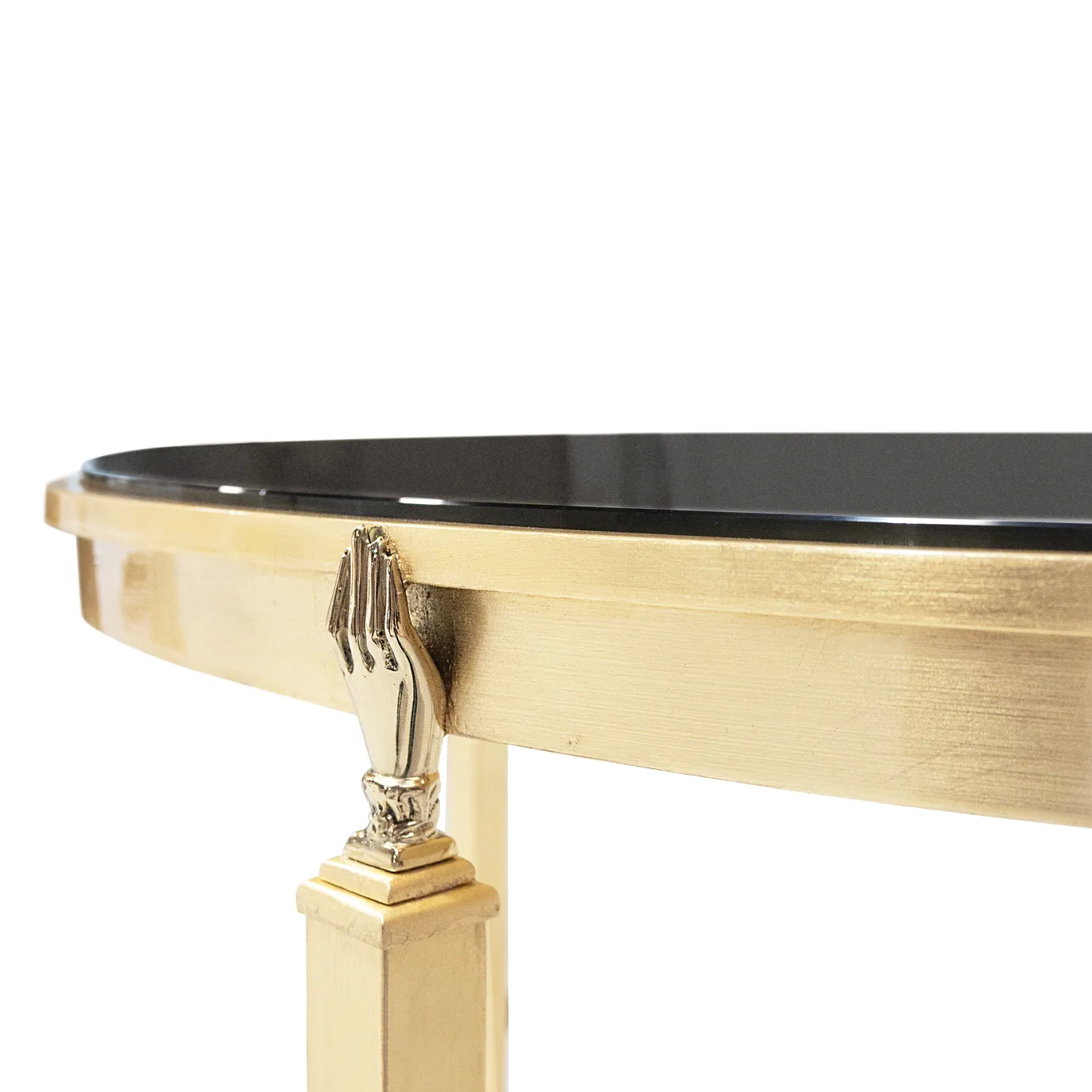 Close-up: Gisele Console's elegant gold hand detail gracefully supporting the sleek black tabletop. Exquisite craftsmanship.