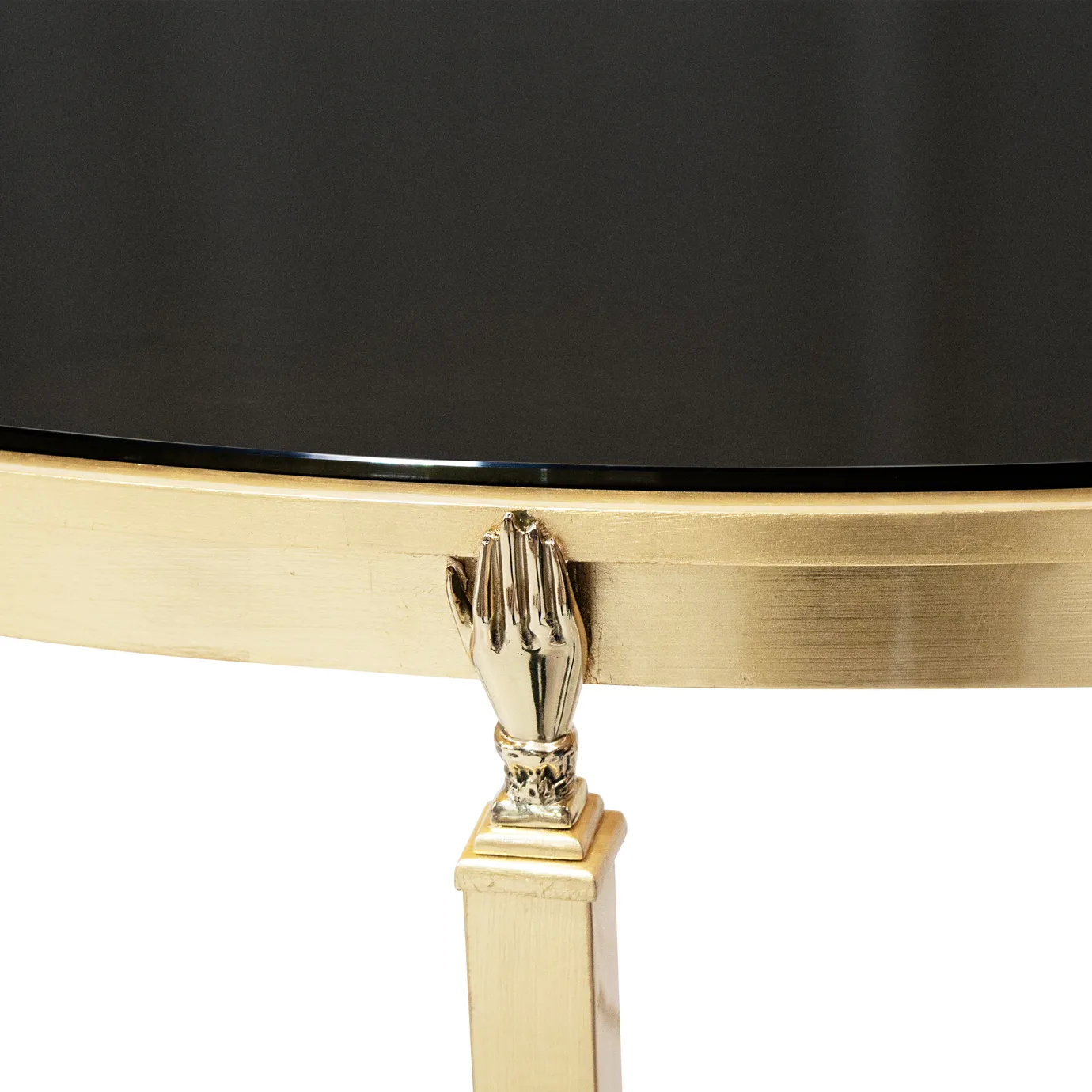 Gisele Console's refined gold hand detail connecting the slender leg to the elegant, dark semi-circular top.