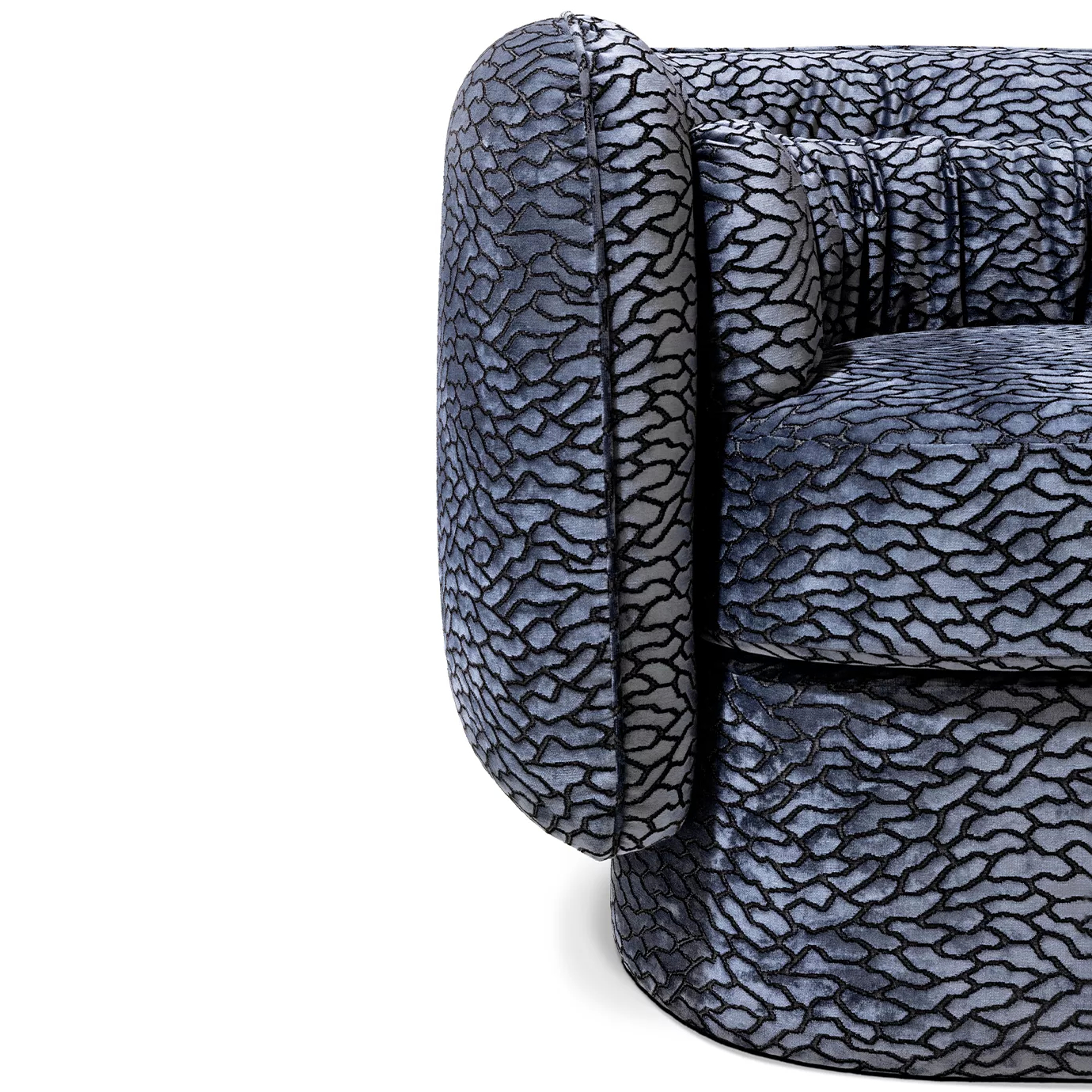 Close-up on the Deb Sofa's armrest, highlighting its unique textured upholstery and soft, rounded form.