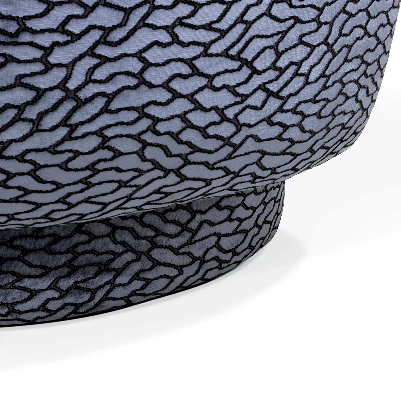 Close-up on the Deb Loveseat's base, highlighting its matching textured upholstery and slightly rounded platform.
