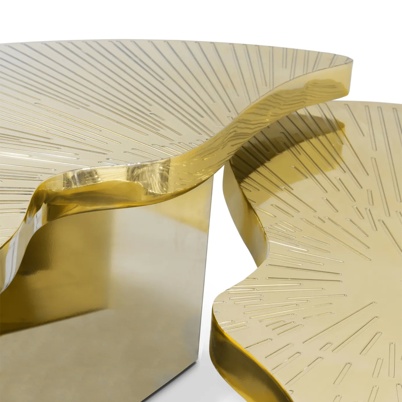Detailed view of the different heighted parts of the Myth Coffee Table, showcasing the engraved tabletops on the polished brass table.
