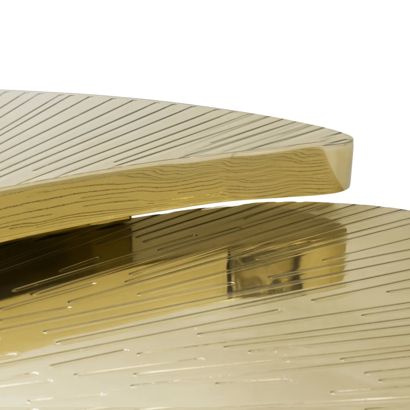 Close-up of the golden Myth Coffee Table's different heighted sections, highlighting the intricately engraved tabletops.