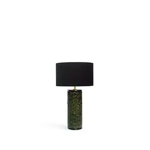 Tailor Peacock Feather Table Lamp with a cylindrical base covered in green peacock feathers and a round black lampshade.