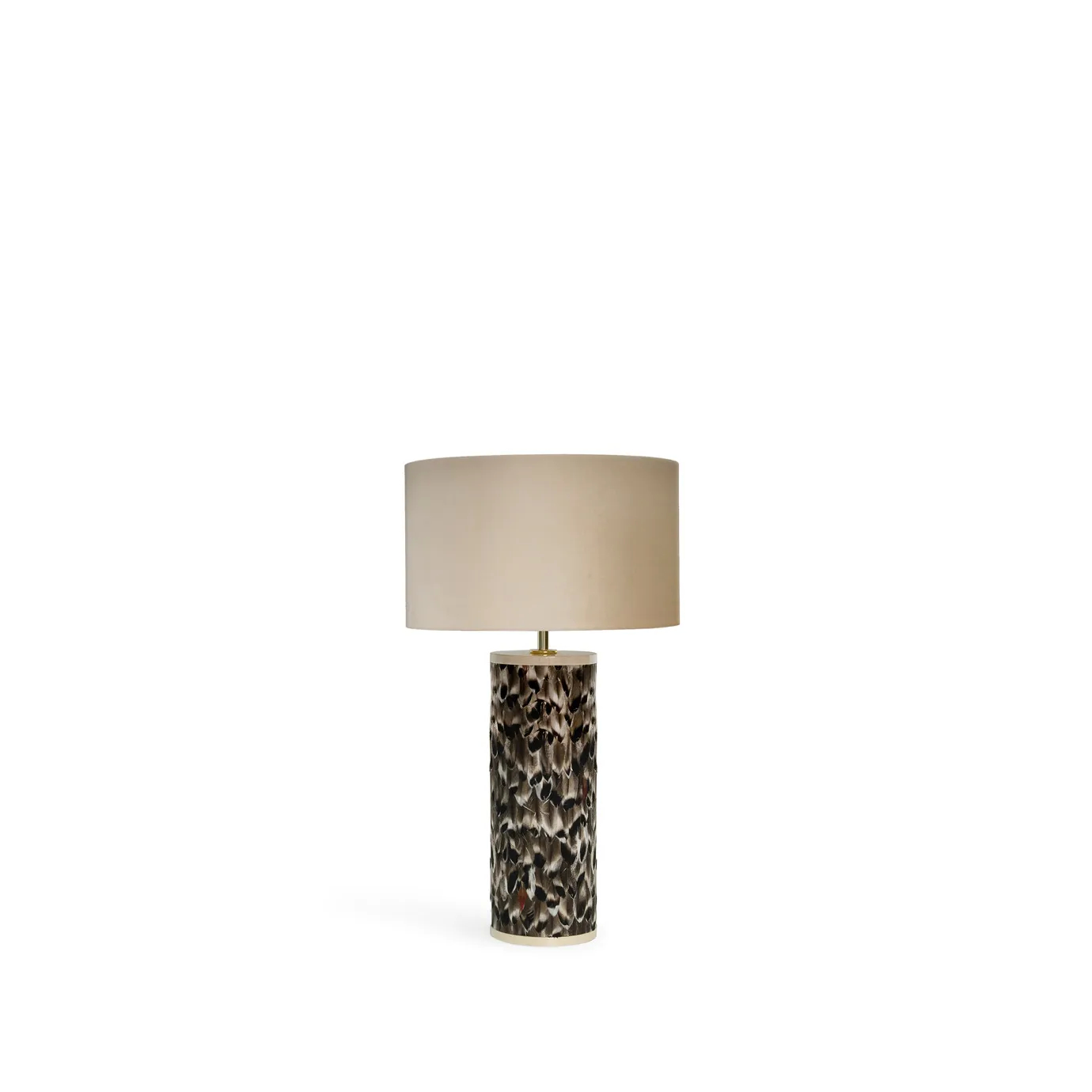 Tailor Folie Feather Table Lamp with a cylindrical base adorned with dark feathers and a round, light beige lampshade.
