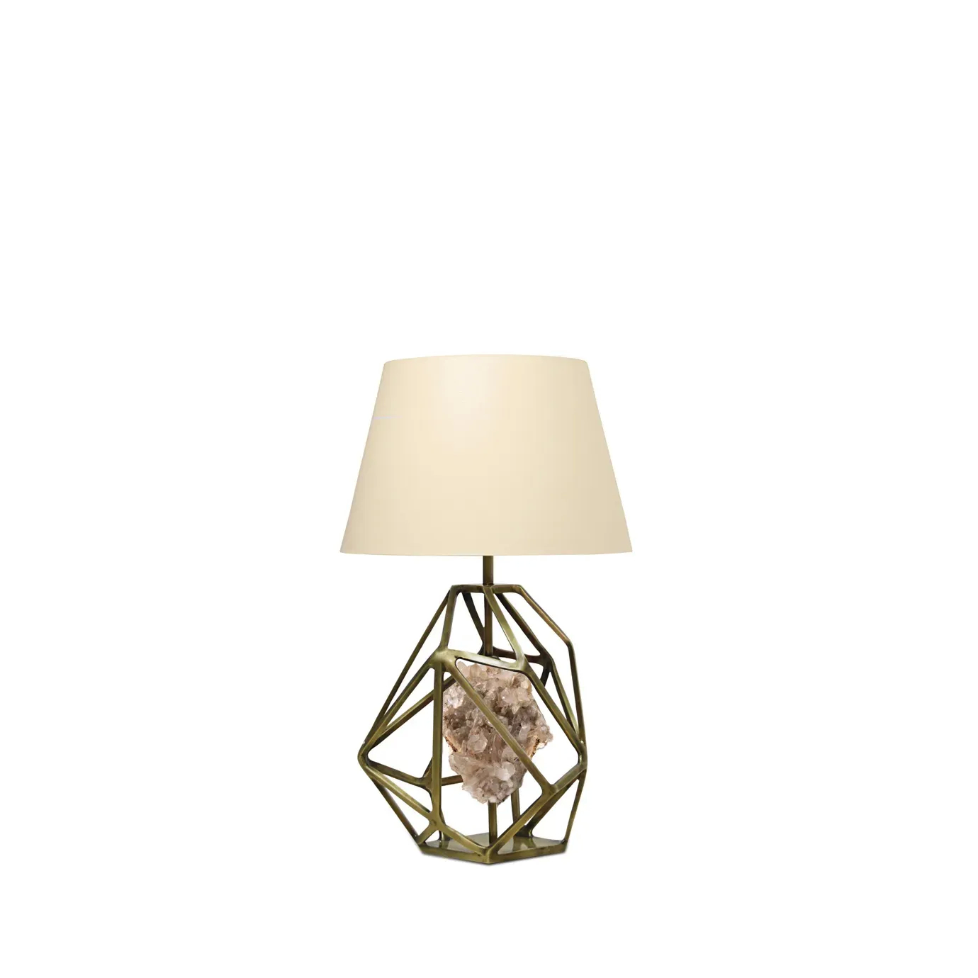 Gem Crystalized Table Lamp with a geometric brass base cradling a raw crystal and topped with a beige lampshade.