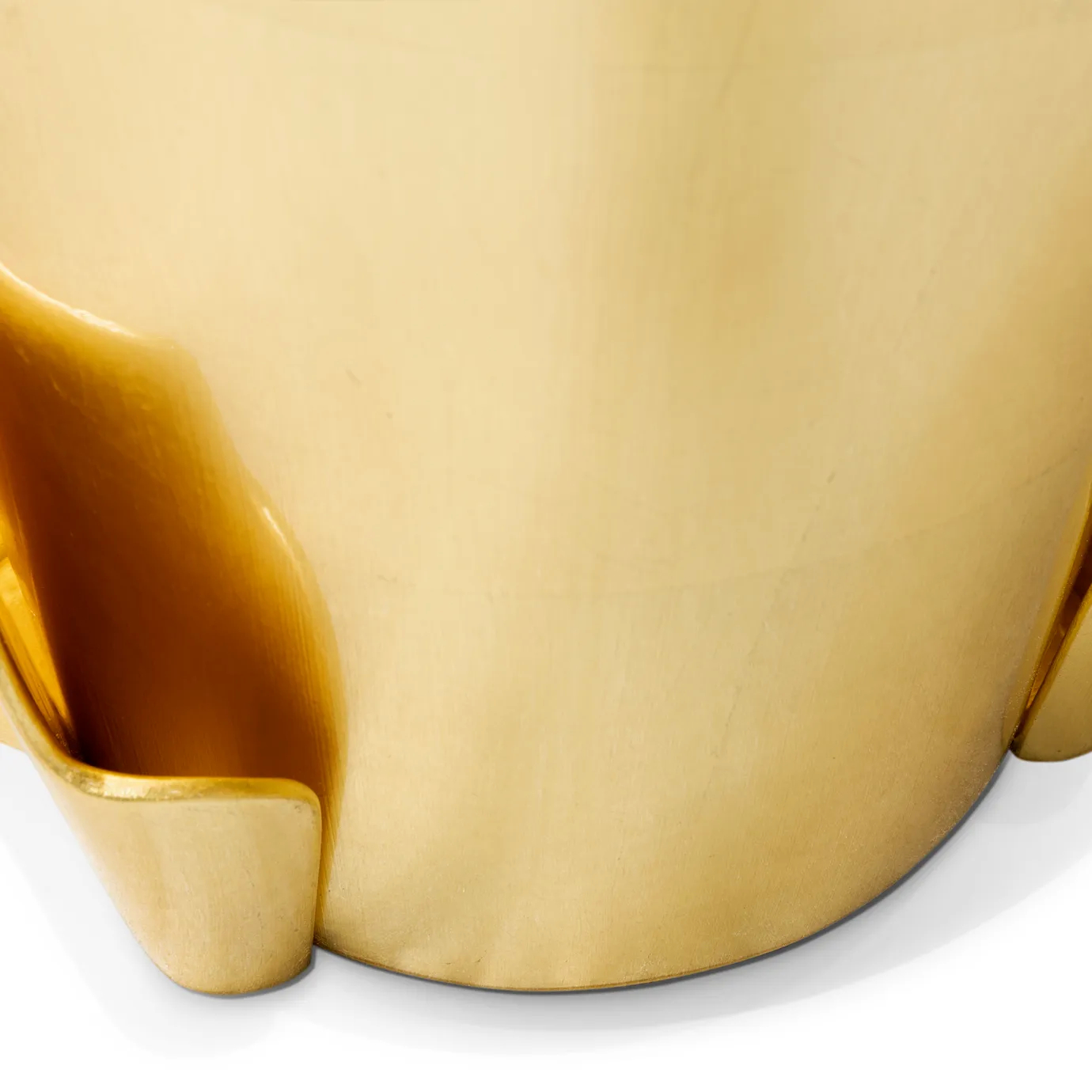Detailed view of the Yasmin Gold Leaf Side Table’s golden base, surrounded by an also golden structure.