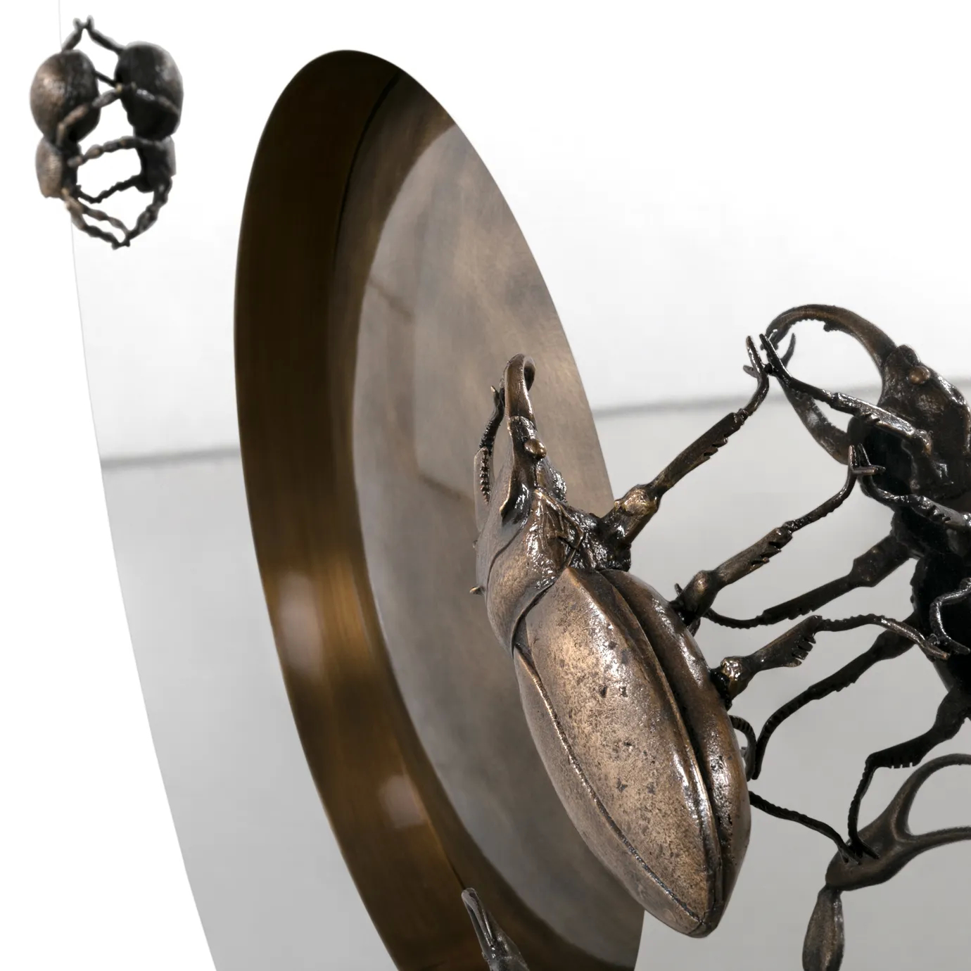 Close-up of Metamorphosis Console, highlighting detailed insect-inspired patterns and sculptural base design.