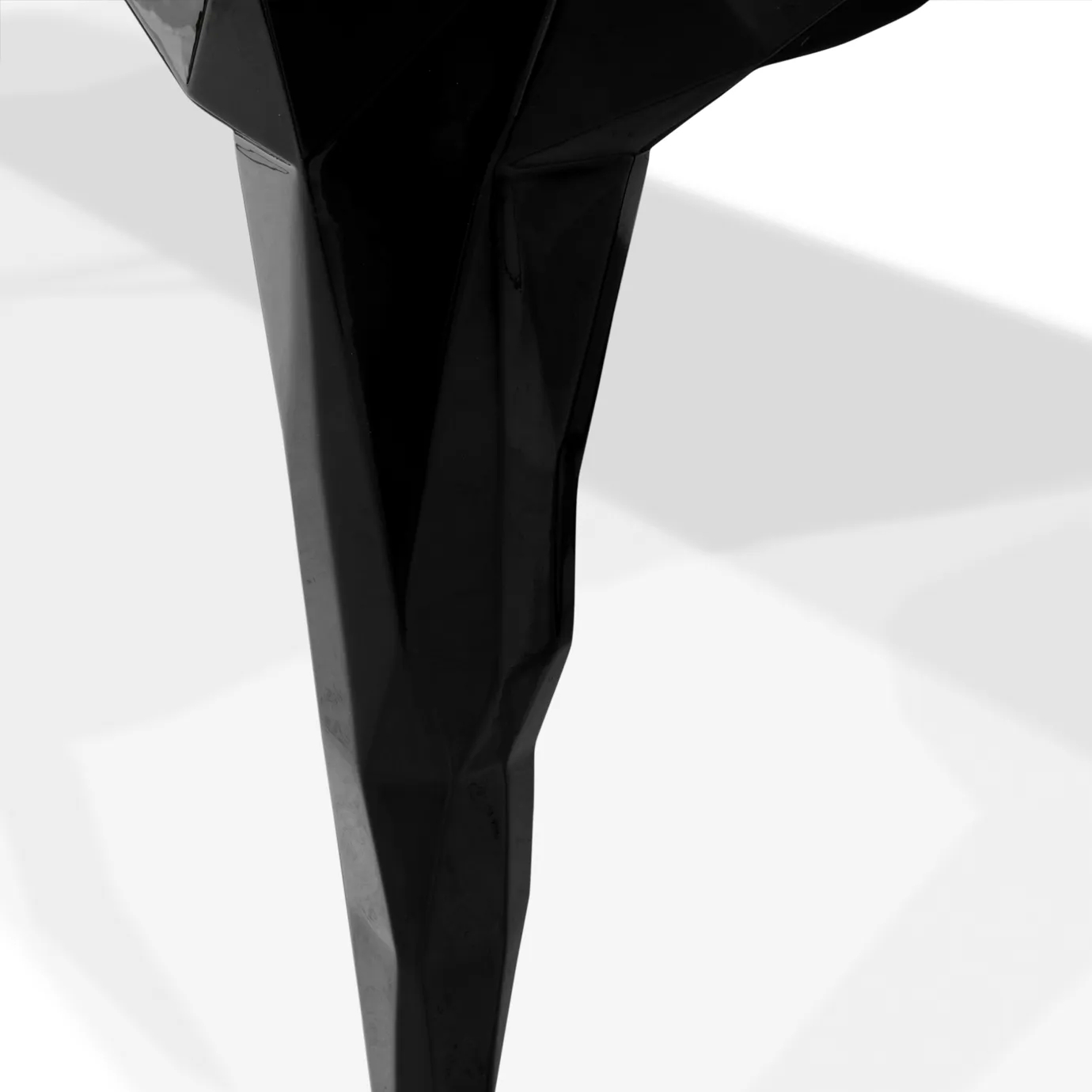 Close-up of Royal Table's luxurious, geometric black leg.