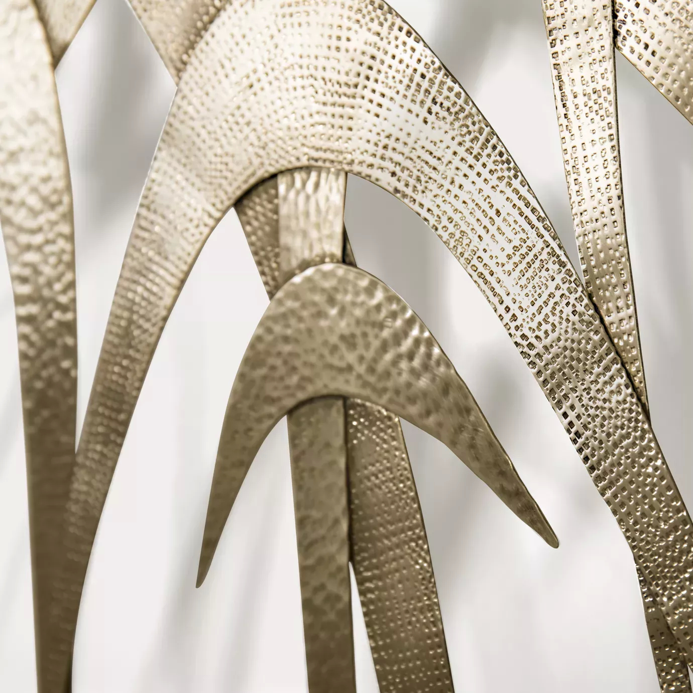 Elegant close-up of the textured golden tone details of the Guilt Mirror.