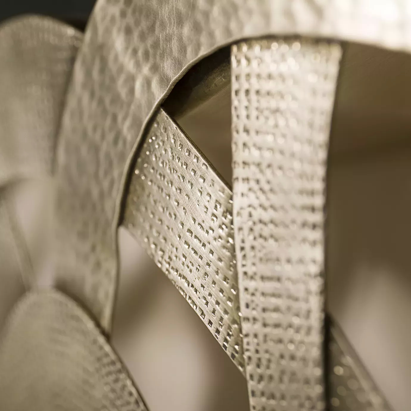 Elegant close-up of the textured golden tone details of the Guilt Mirror.
