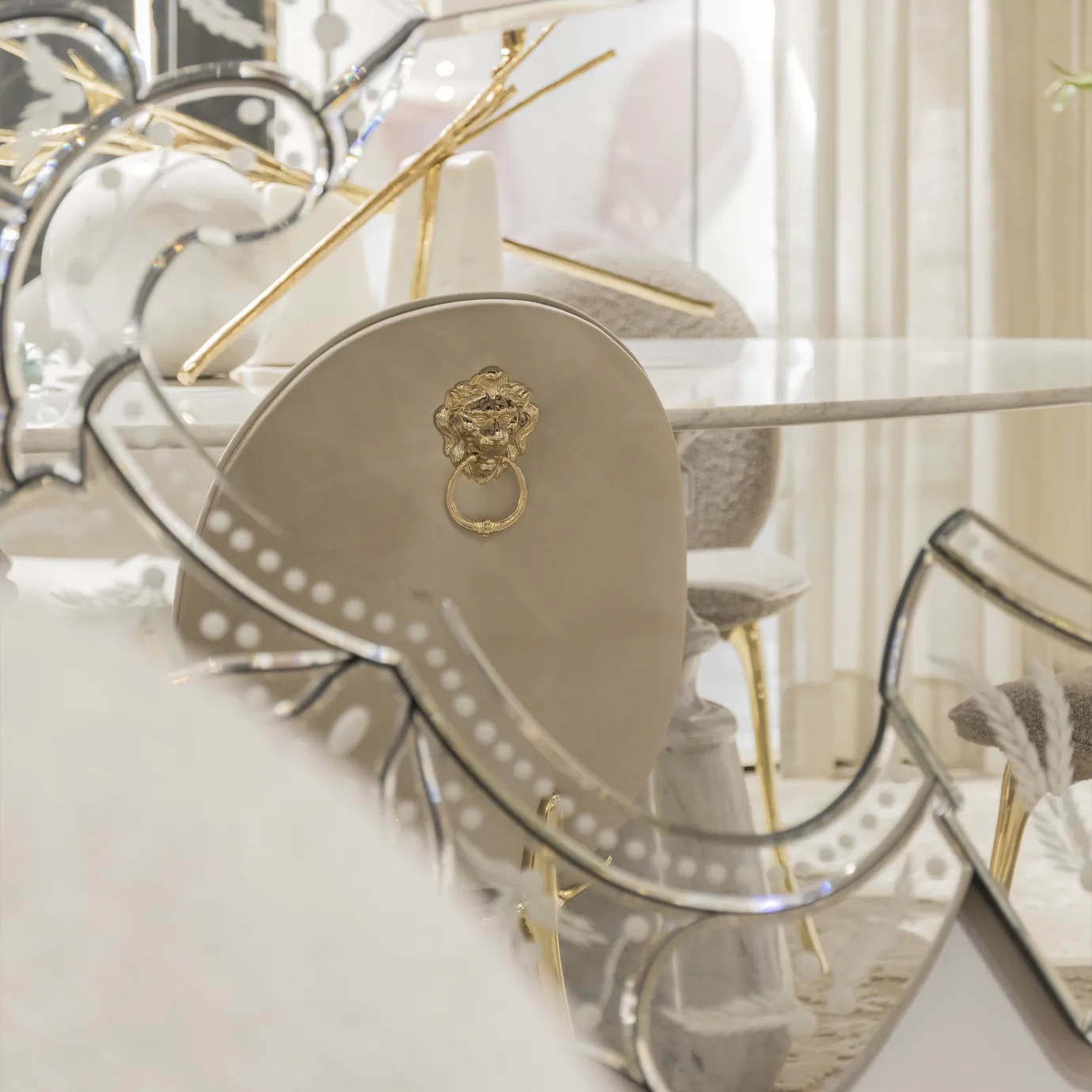 Close-up of the Soleil cream chair's elegant curved backrest with smooth upholstery.