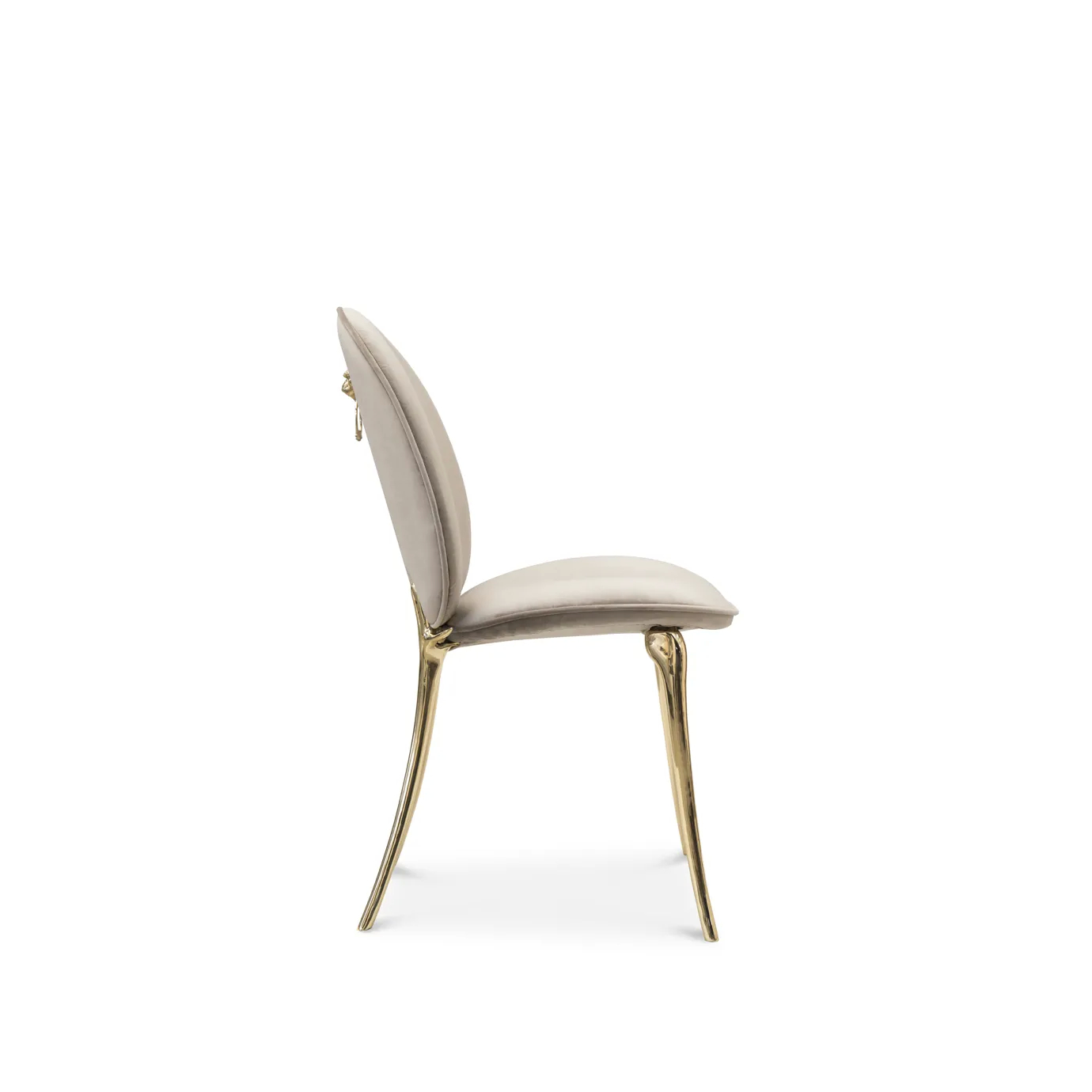 Cream velvet chair with curved backrest and polished brass legs.
