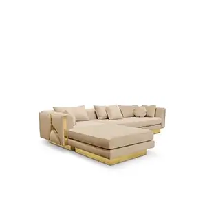 A luxurious L-shaped modular sofa with polished brass accents and plush beige upholstery.
