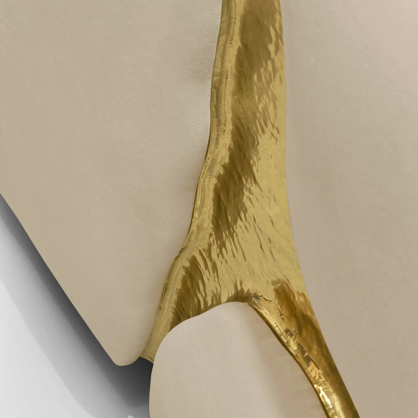 Close-up of brass and velvet detail showcasing refined craftsmanship and luxurious texture.