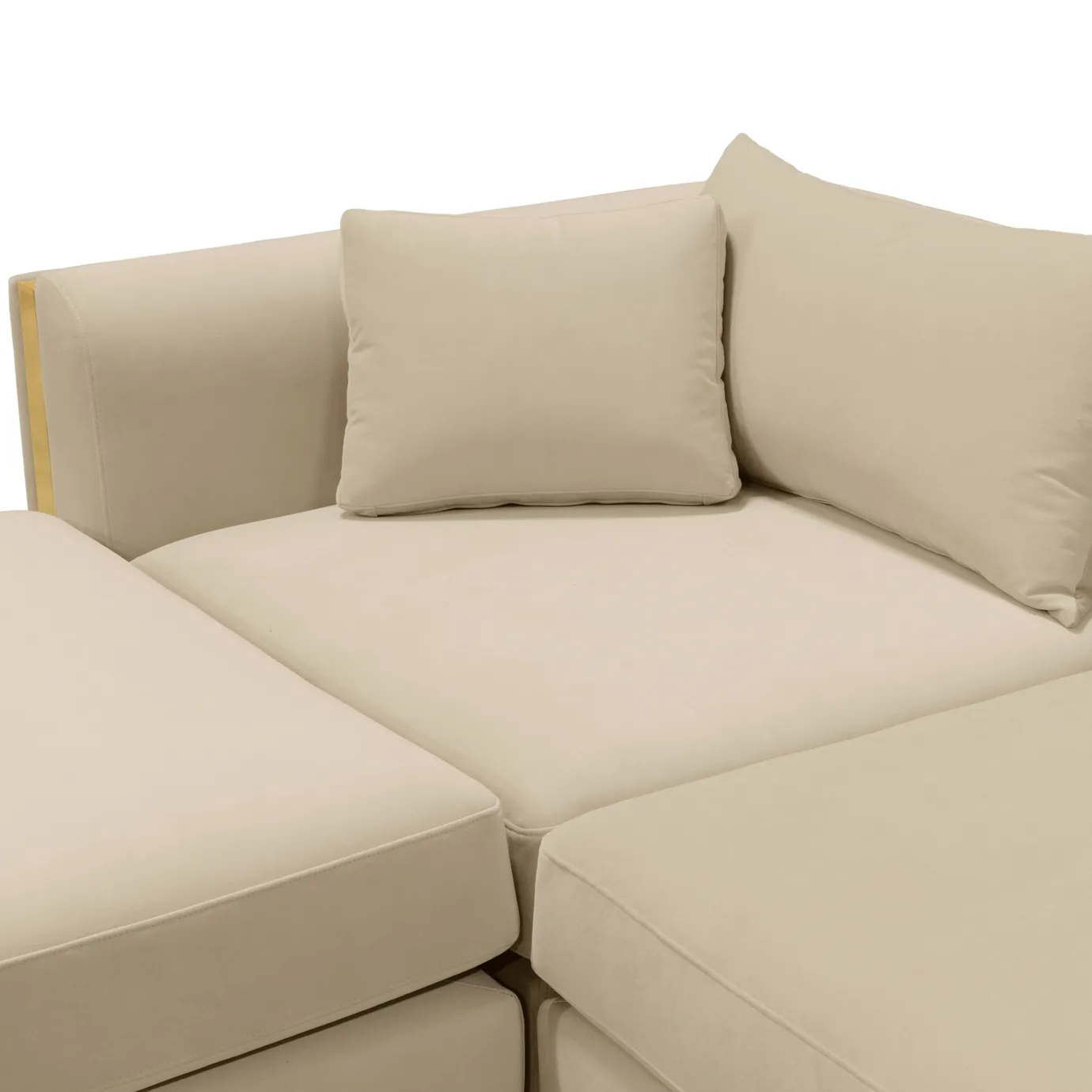 Close-up of plush velvet cushions with golden brass accents