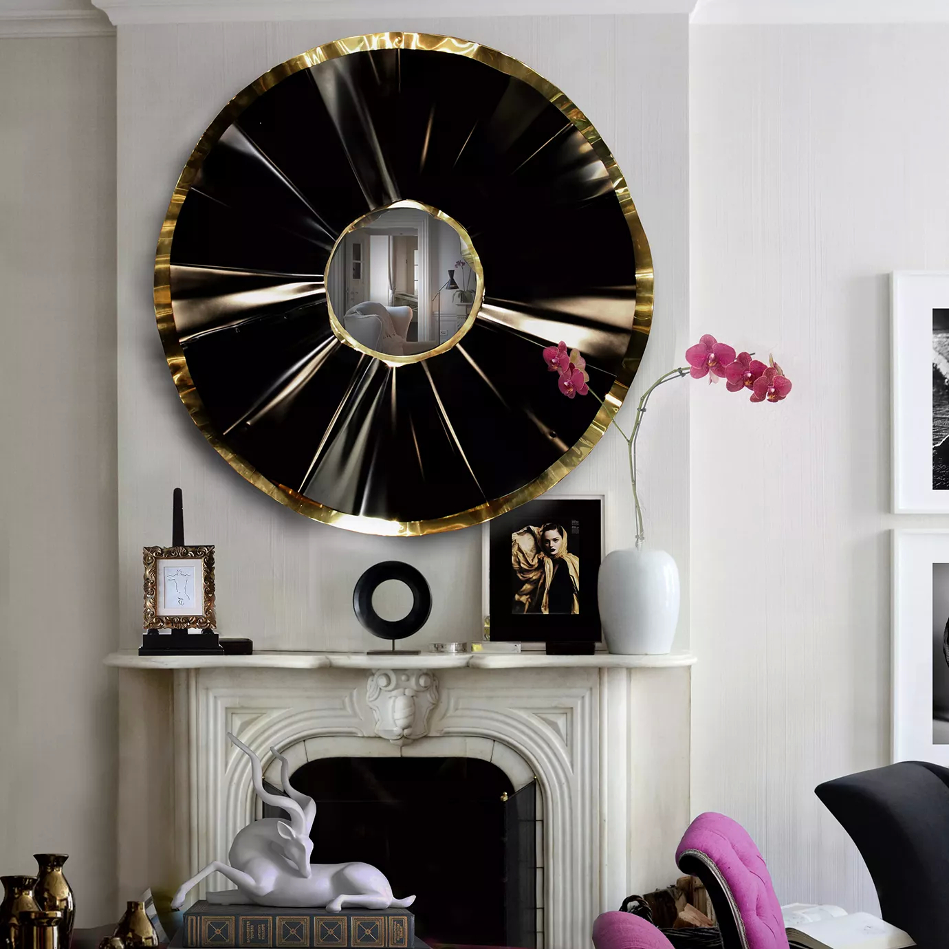 An elegant living room with fireplace adorned by various décor accessories, such as frames and an orchid, bringing a touch of color to the room. Above the fireplace, a Revê 2  Tier Mirror is hang. The convex mirror is complemented by a two-ring frame, a black one on the inside and a golden one on the outside.