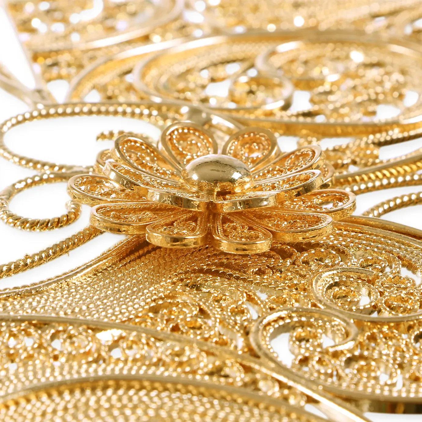 Close-up detail of the filigree mirror’s ornate metal frame, highlighting intricate scrollwork patterns and antique finish with refined craftsmanship