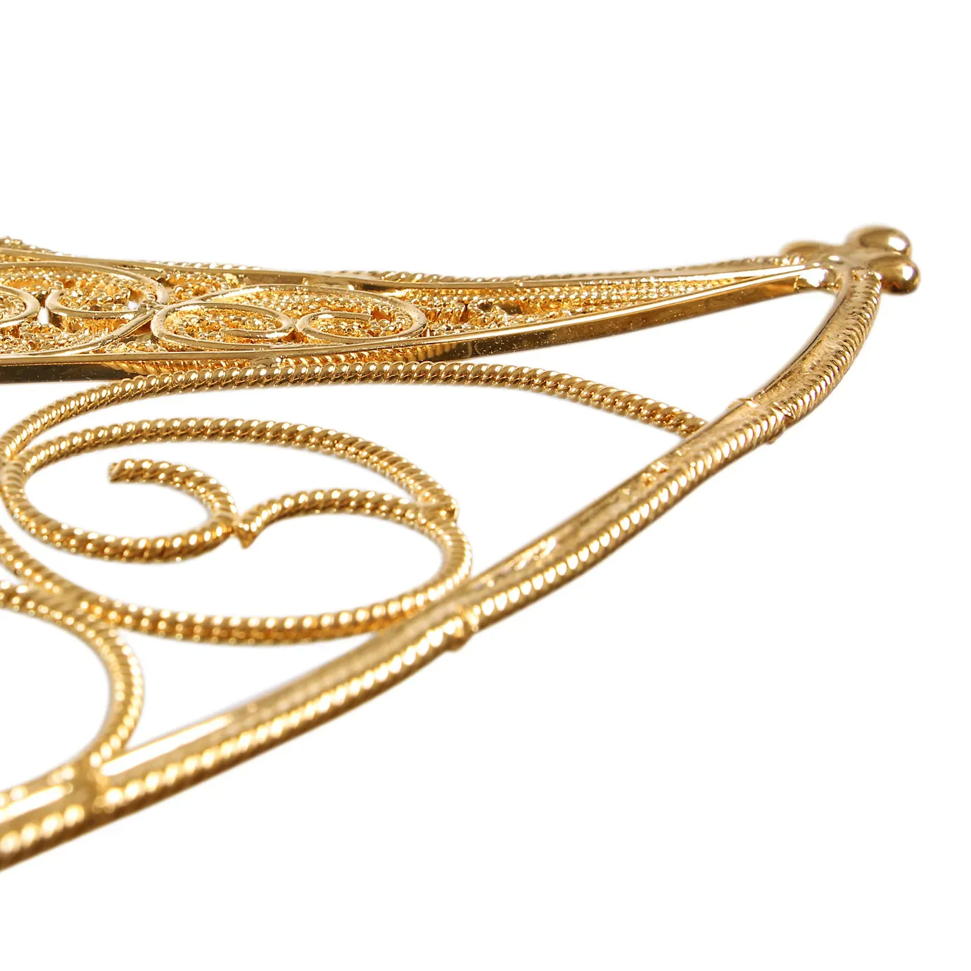 Ornate mirror with intricate filigree metalwork, showcasing detailed patterns and a luxurious antique finis.