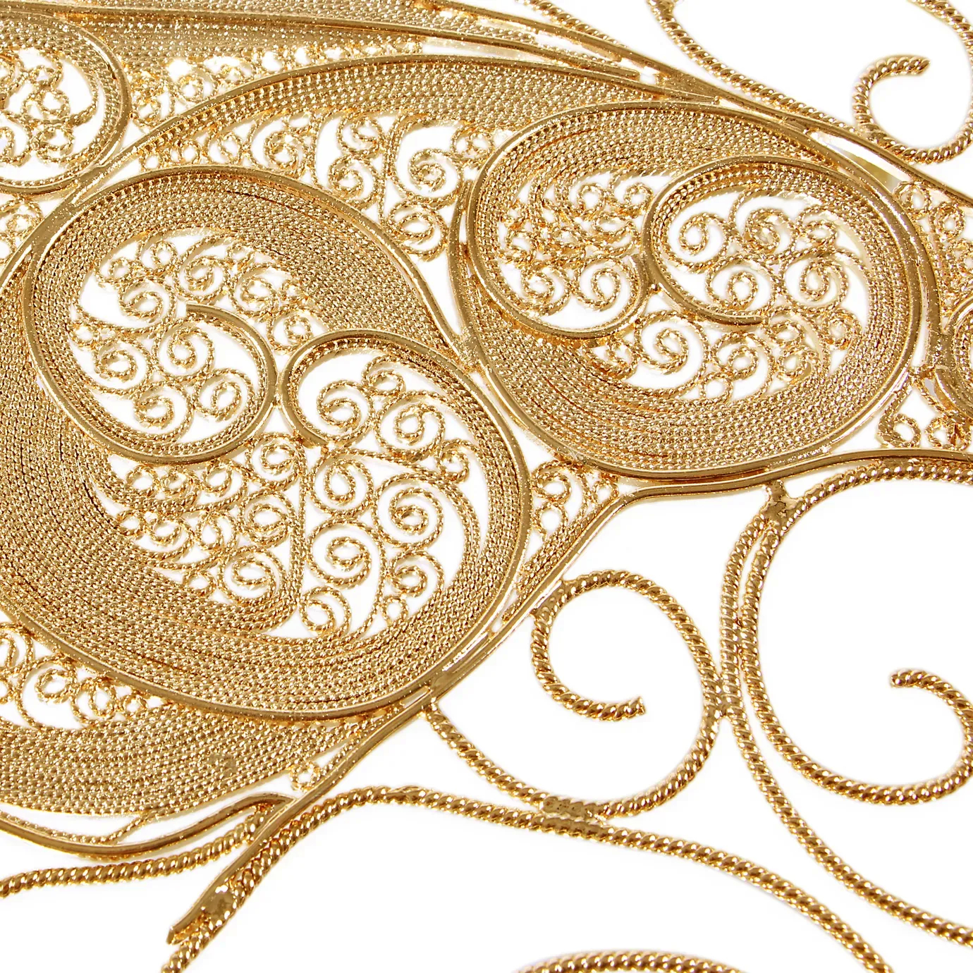 Close-up view of the filigree mirror’s decorative frame, showcasing detailed metal scrollwork and antique finish with elegant, handcrafted artistry