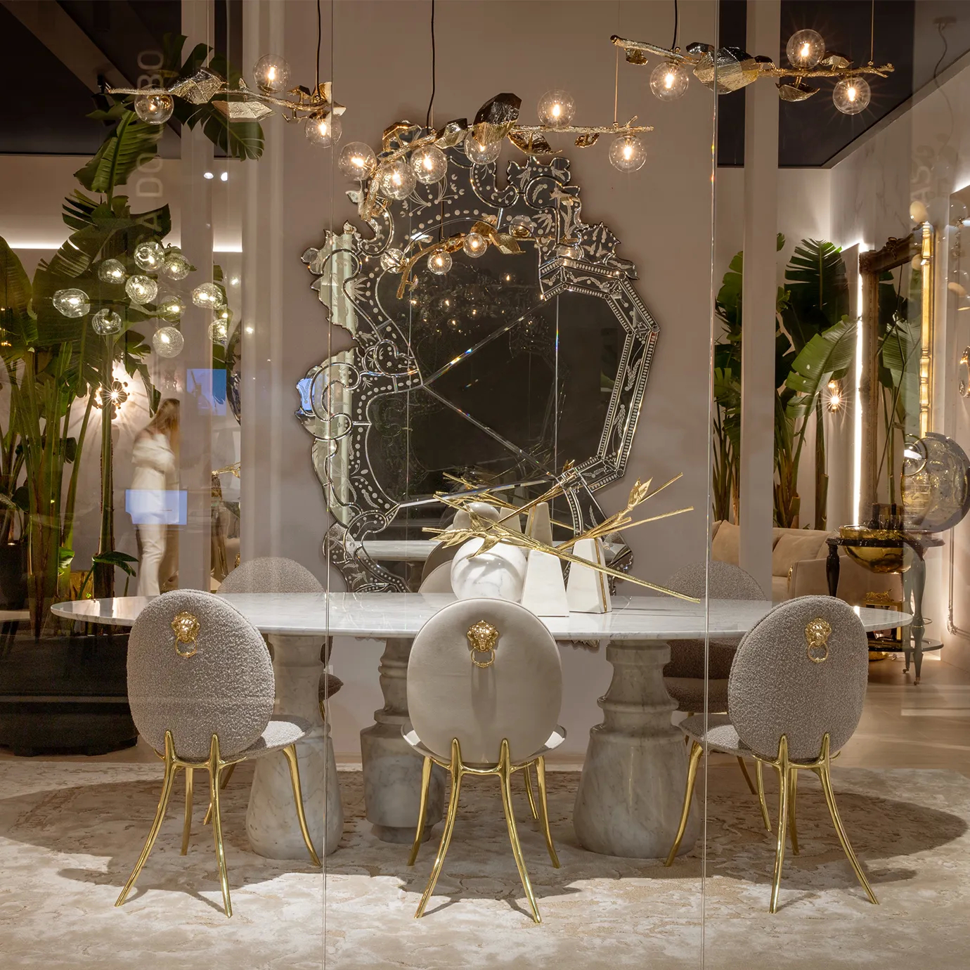 Venetian-style mirror with ornate gold frame enhances a luxurious bedroom interior, reflecting classic elegance and refined design