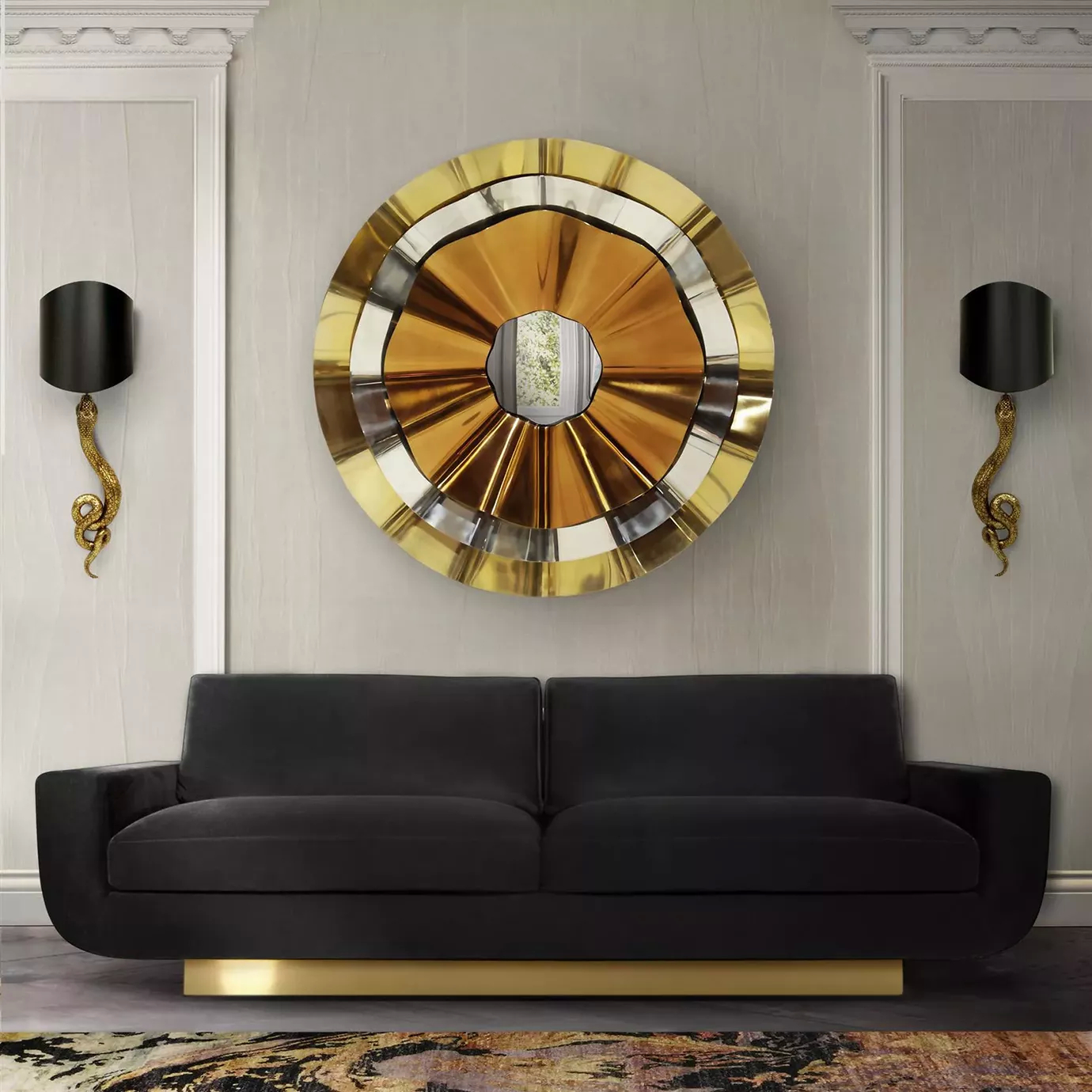 A sophisticated living room with a black sofa with a golden base. Above the sofa, there’s a Revê 3 Tier Mirror, with three rings, a golden, a silver and a copper one framing a convex mirror. Next to the mirror there are two sconces.
