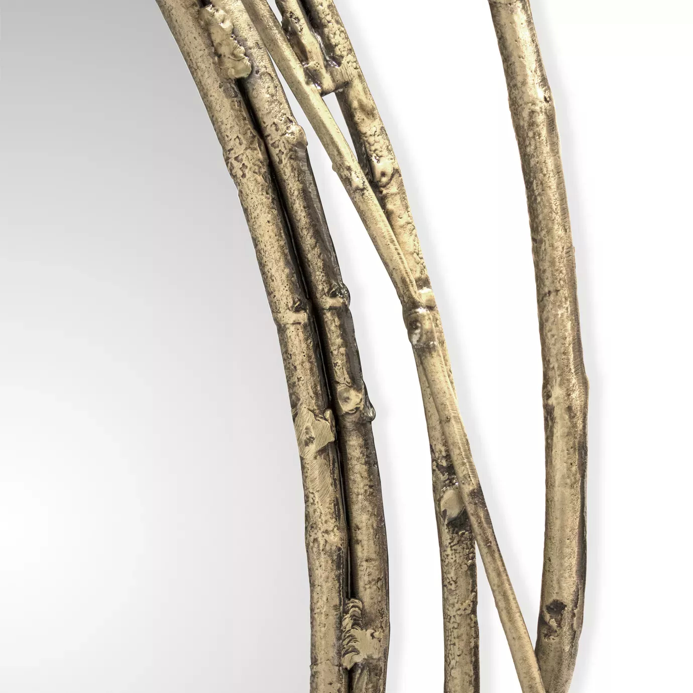 A close-up view of the Stella Mirror copper frame, designed to resemble intertwined stems. The frame has a textured surface with naturalistic details, highlighting the craftmanship.