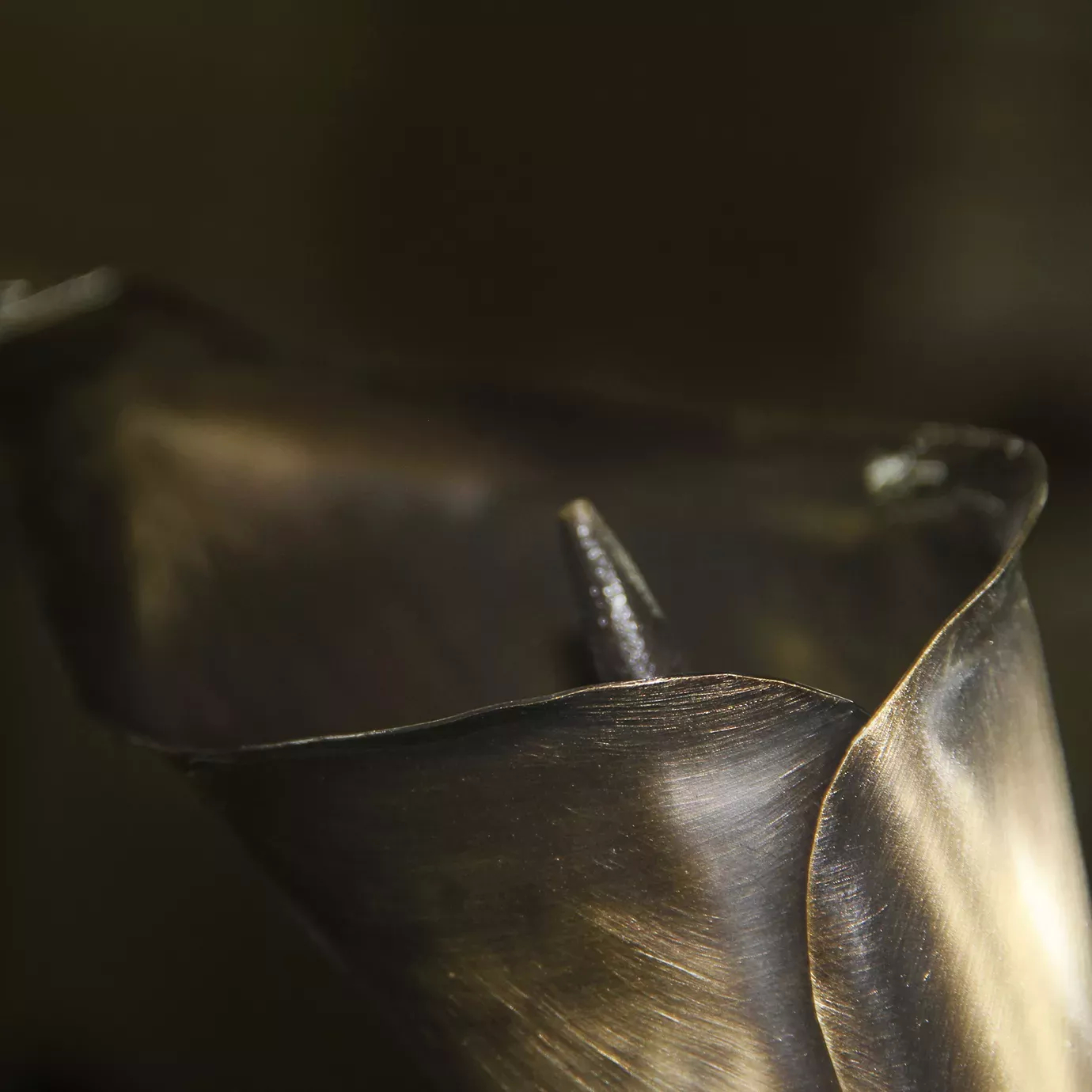Detailed view of a meticulosly handcrafted Calla Lily, part of the Stella Mirror frame, showcasing copper tones.