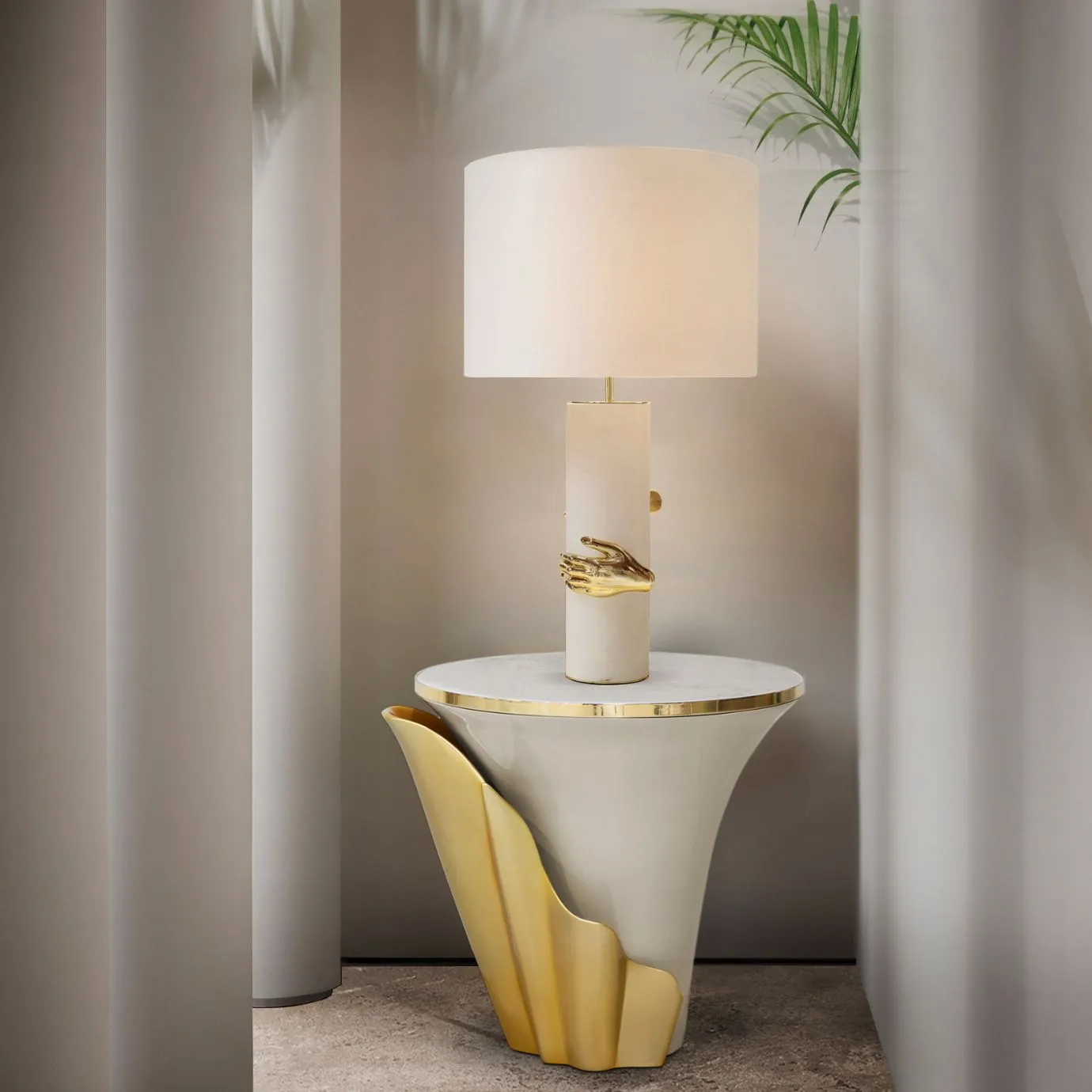 Yasmine Mother of Pearl Side Table by KOKET featuring sculptural gold accents and a white table lamp in an elegant luxury interior