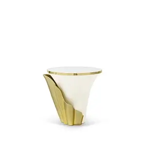 Featuring a sultry silhouette, Yasmine Mother of Pearl Side Table has a Mother of Pearl tabletop with golden edges, set on a cream wooden base, adorned with an golden structure that arches back and forth.