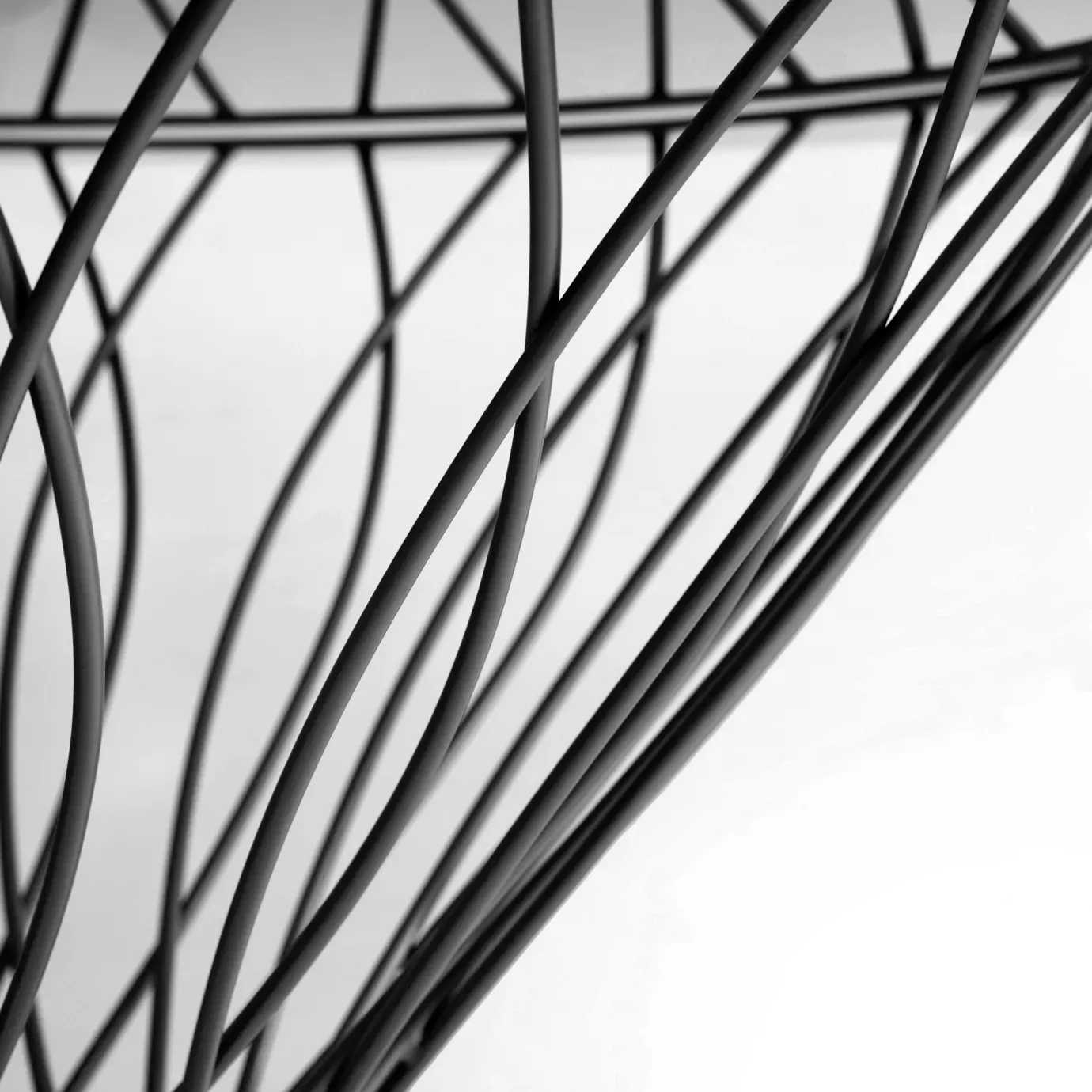 Close up on the Allure Dining Table’s black silhouette-shaped structure.