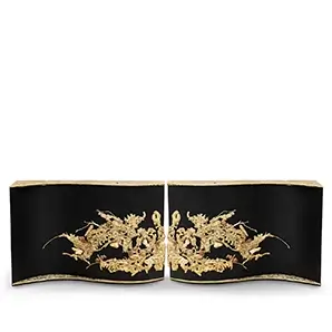 Front view of the Empress Console by KOKET, featuring a curved black wood structure with cast brass details and amber crystal inlays.