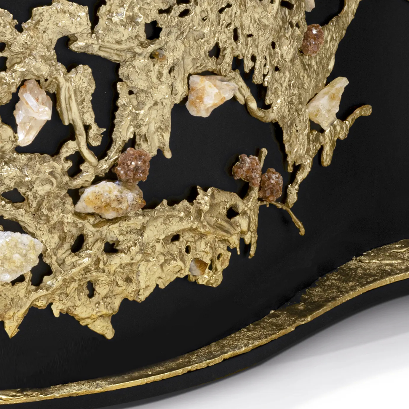 Close-up of natural crystal inlays—aragonite, Brazilian citrine, and clear quartz—set within the cast brass façade.
