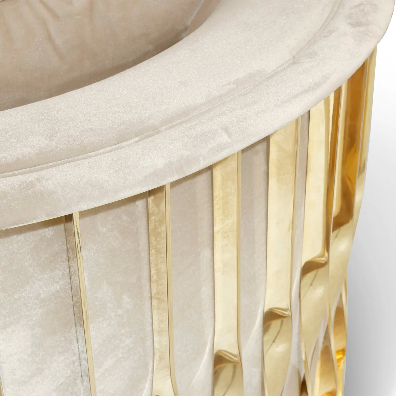 Close-up of the gold frame of Mandy armchair, showcasing its sleek design and luxurious finish.