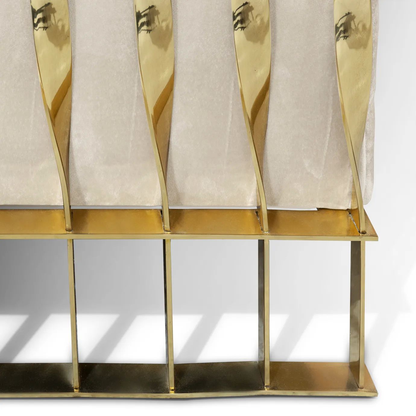 Side view of the legs of Mandy armchair, highlighting the elegant gold accents and sleek, modern design.