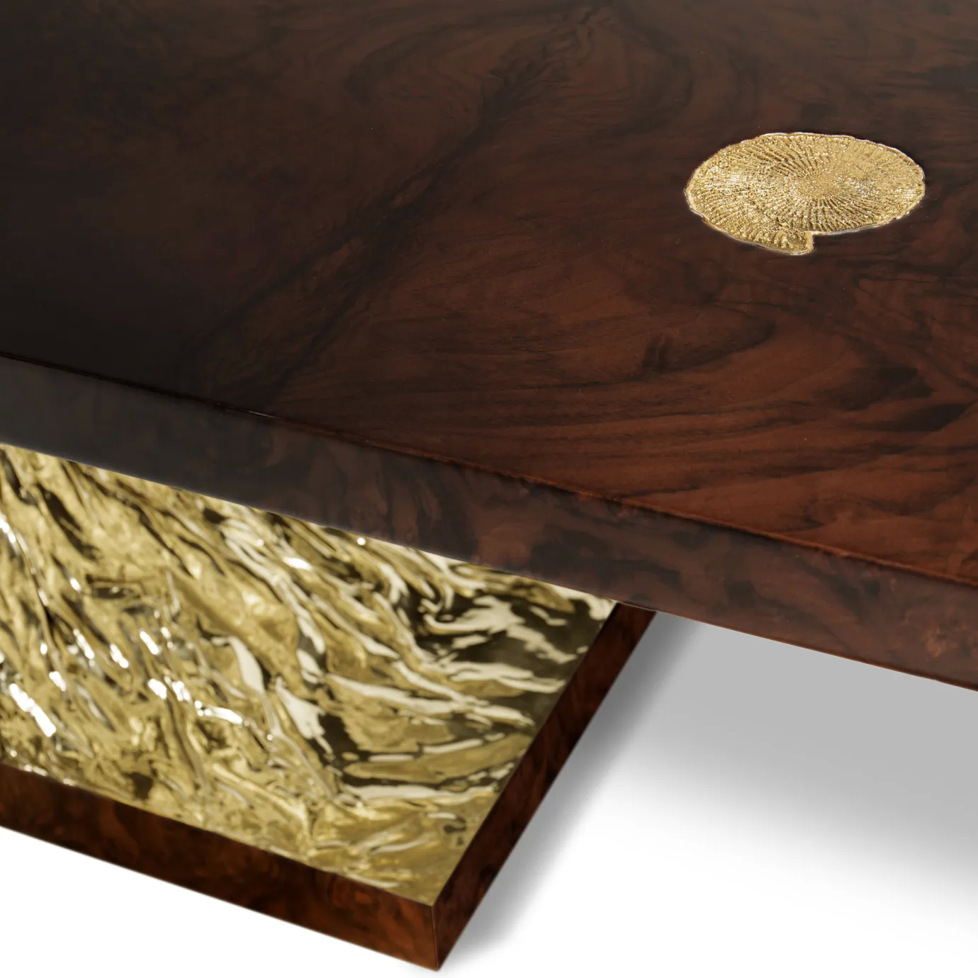 Elegant dining table with a sculptural base and polished marble top in a luxurious setting.