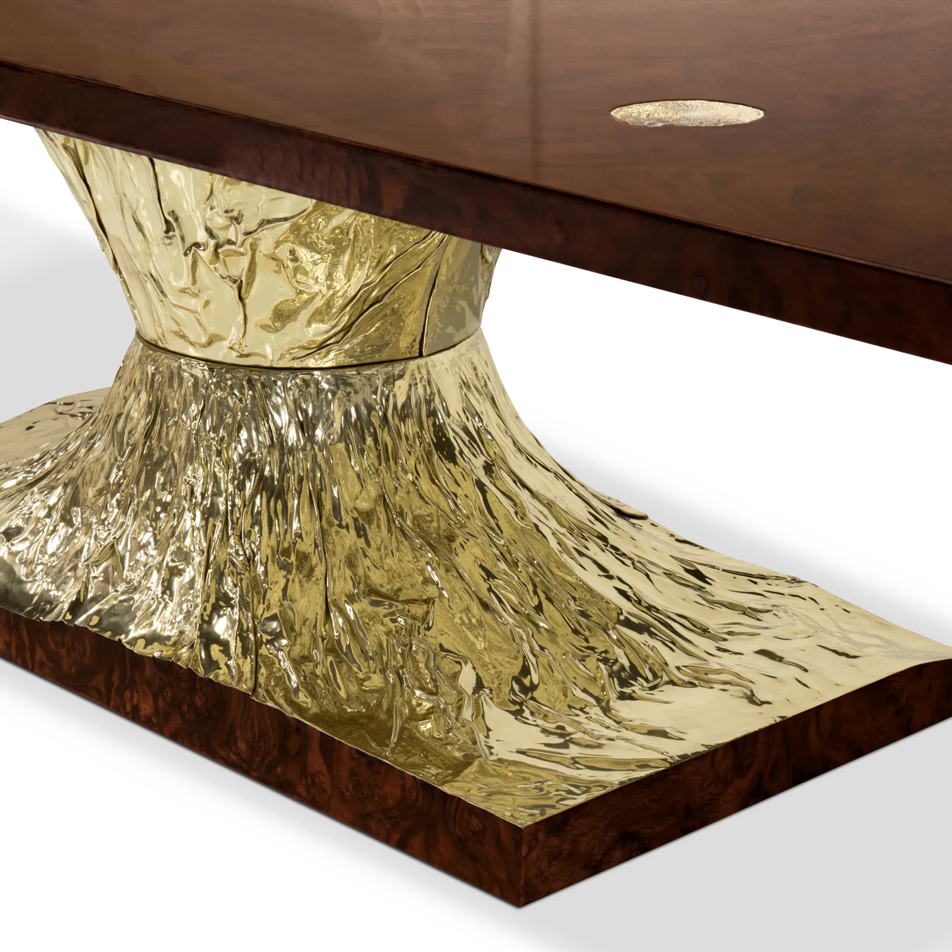 Elegant walnut root veneer dining table with sculpted brass accents and fossil textures.