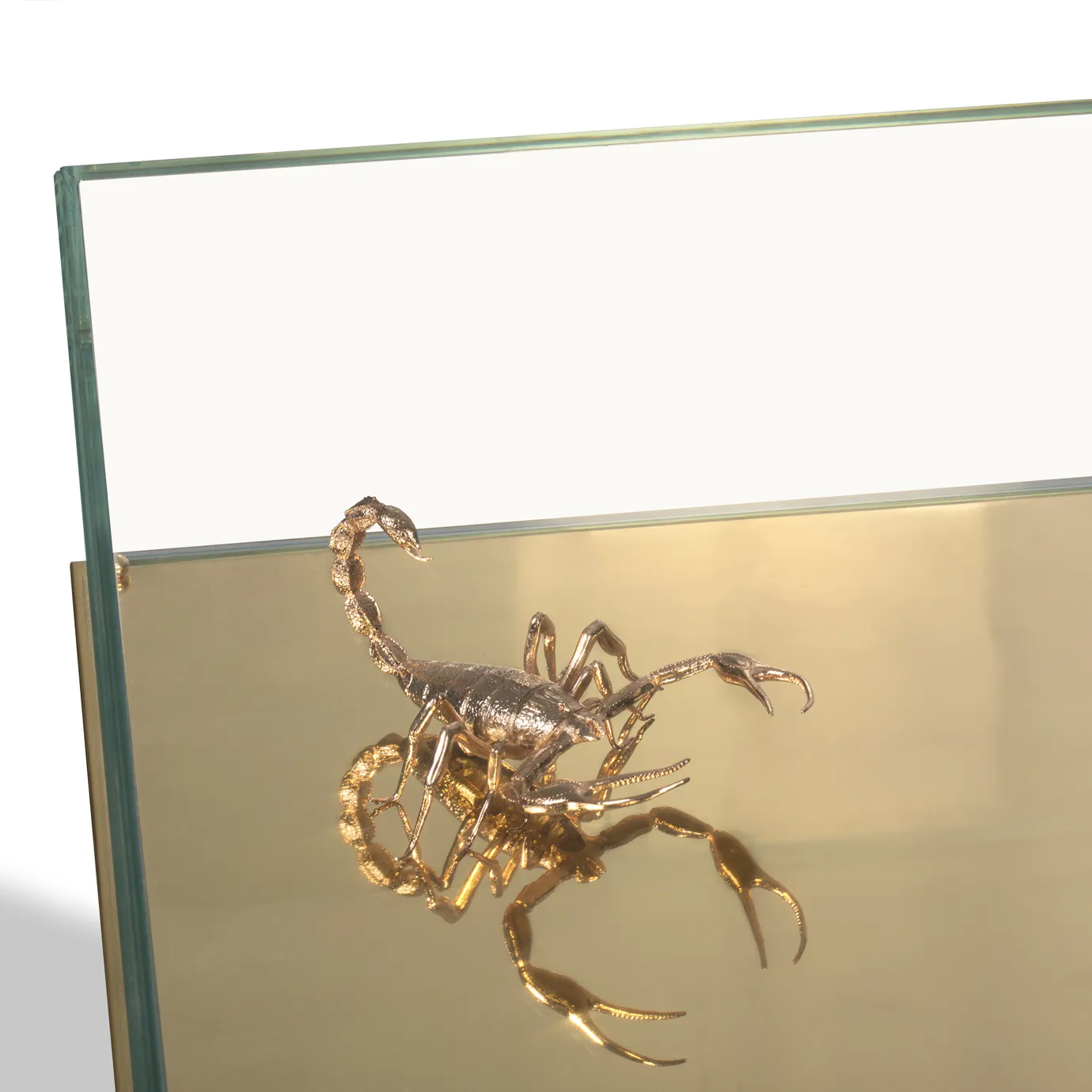 Close-up of a luxurious center table with gold-plated scorpions and marble accents.