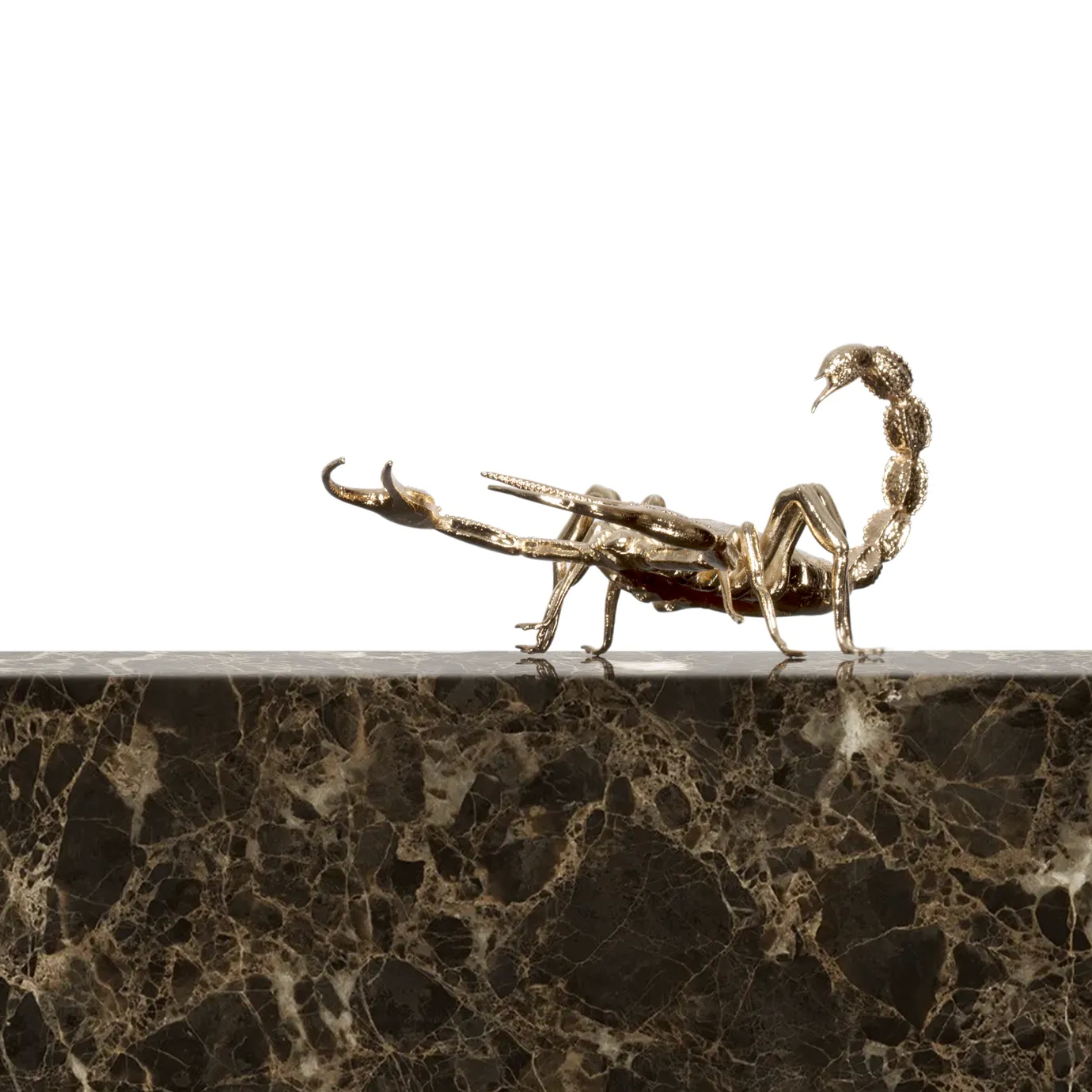 A sleek center table with a glass top, gold accents, and marble detailing.
