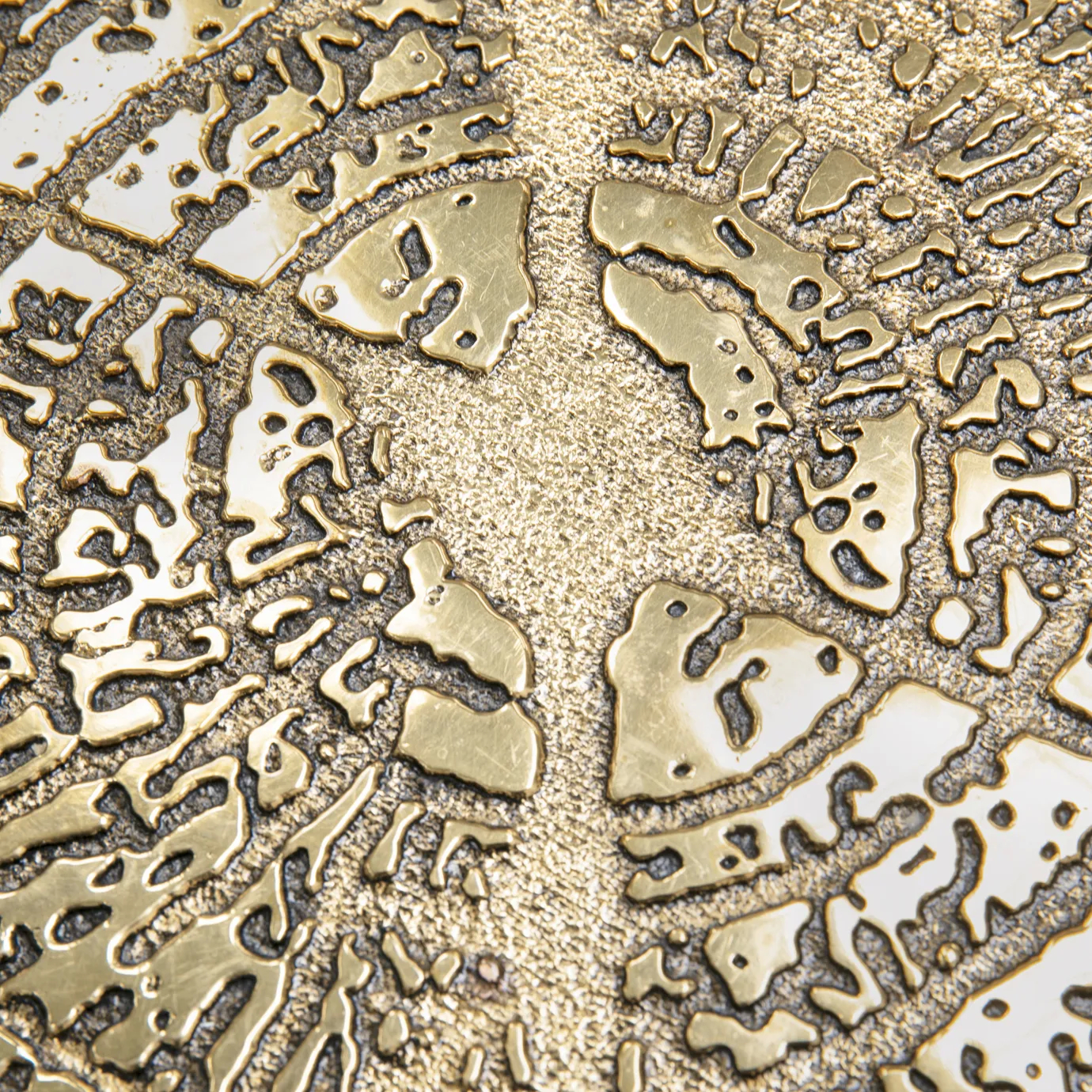 Side view of the marble top with distinctive veining, supported by a sculptural gold base.
